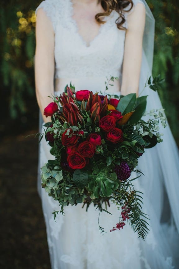 Wedding bouquet with roses, peppercorns and protea