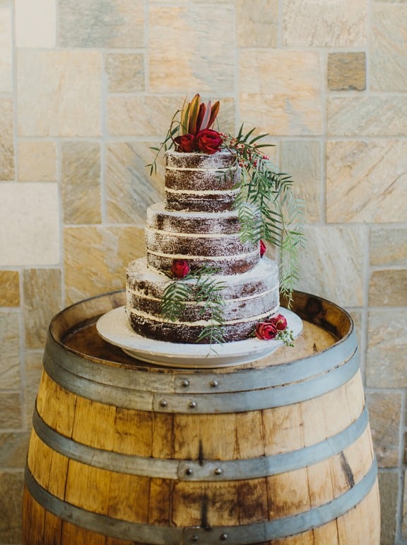 Naked chocolate layer cake with fresh flower topper