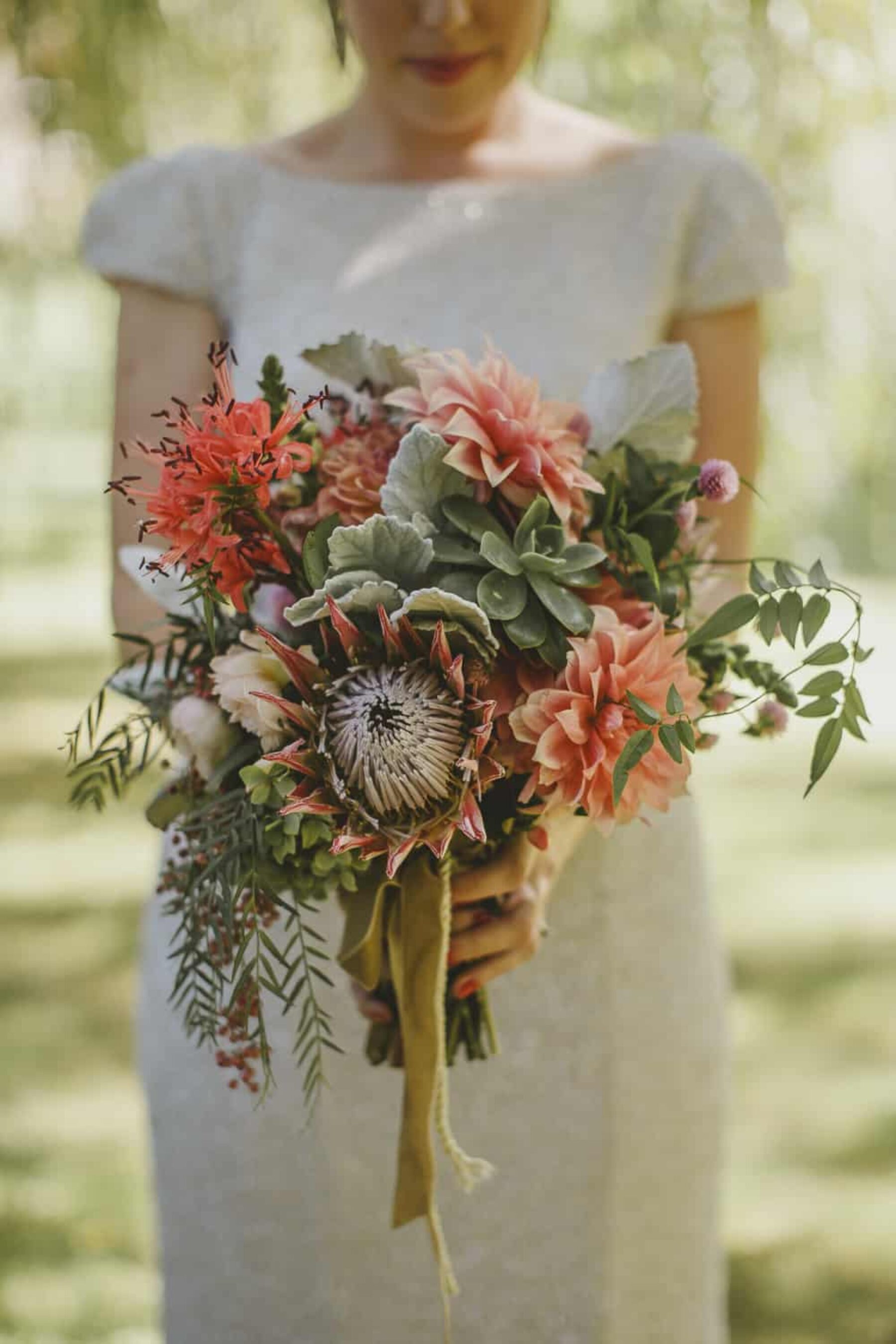 Dahlia and protea bouquet by Mikarla Bauer / Suzanne Harward gown