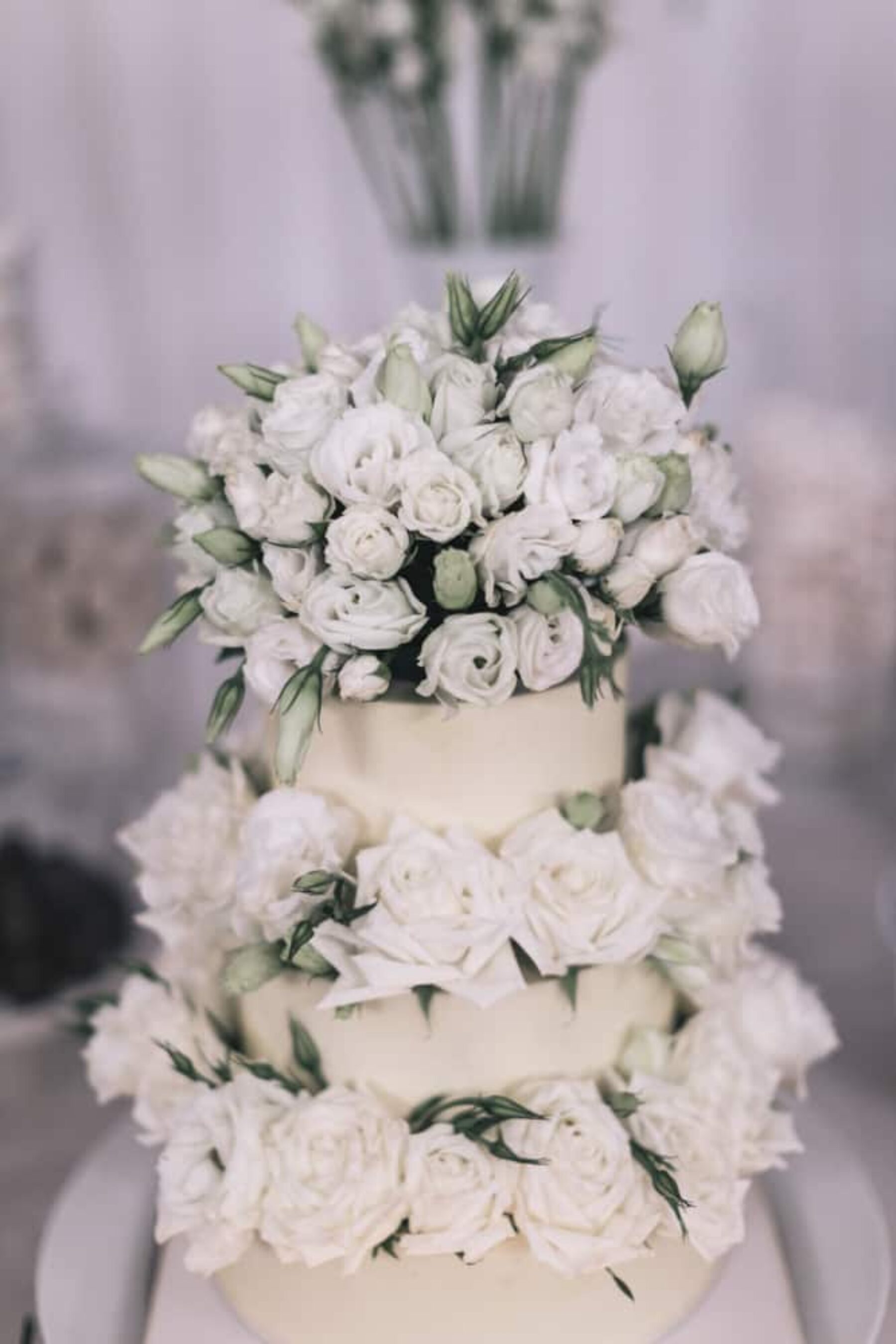 wedding cake dressed with fresh white roses