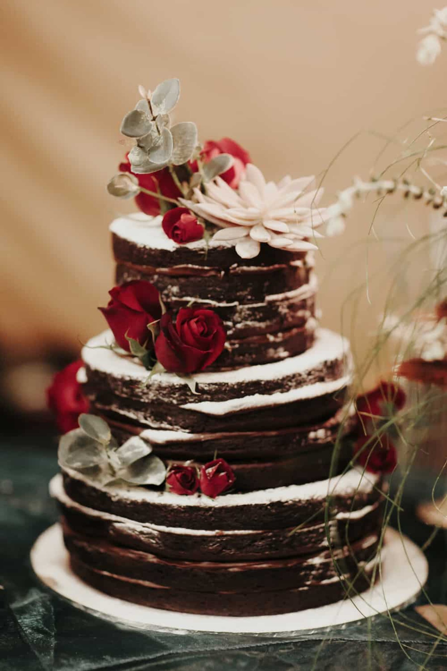 chocolate naked layer cake dressed with fresh flowers