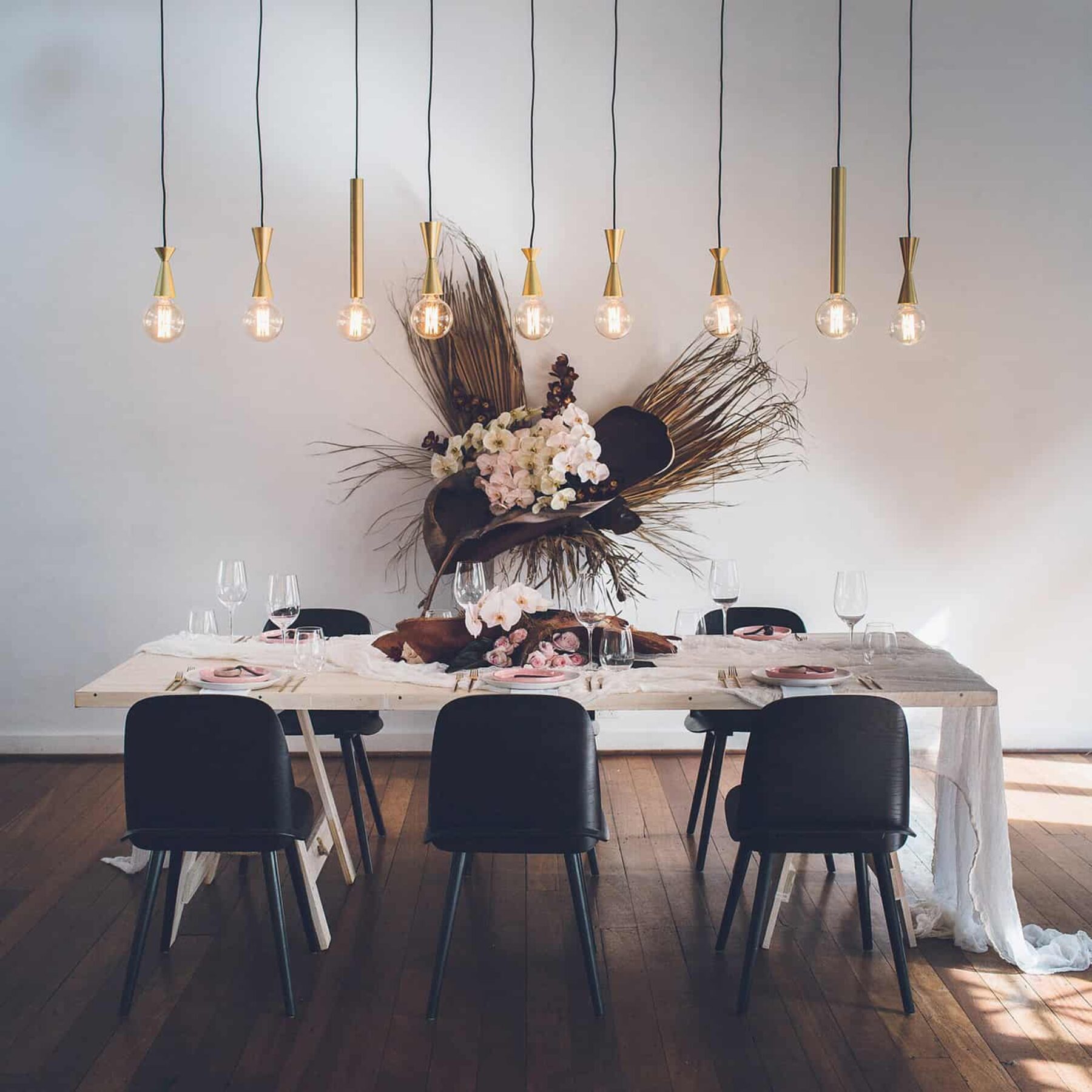 blush and burgundy table setting with hanging pendant lights