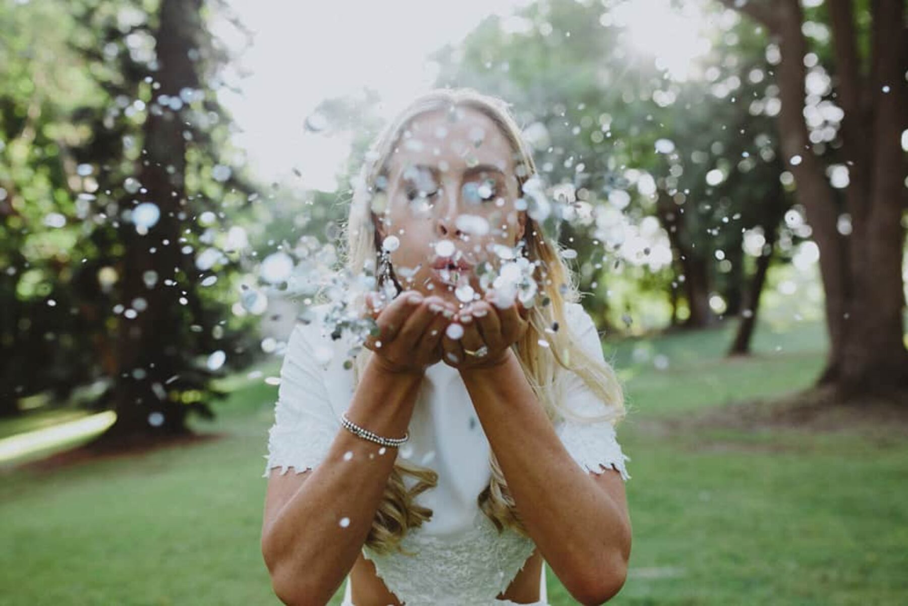 bride blowing confetti kiss