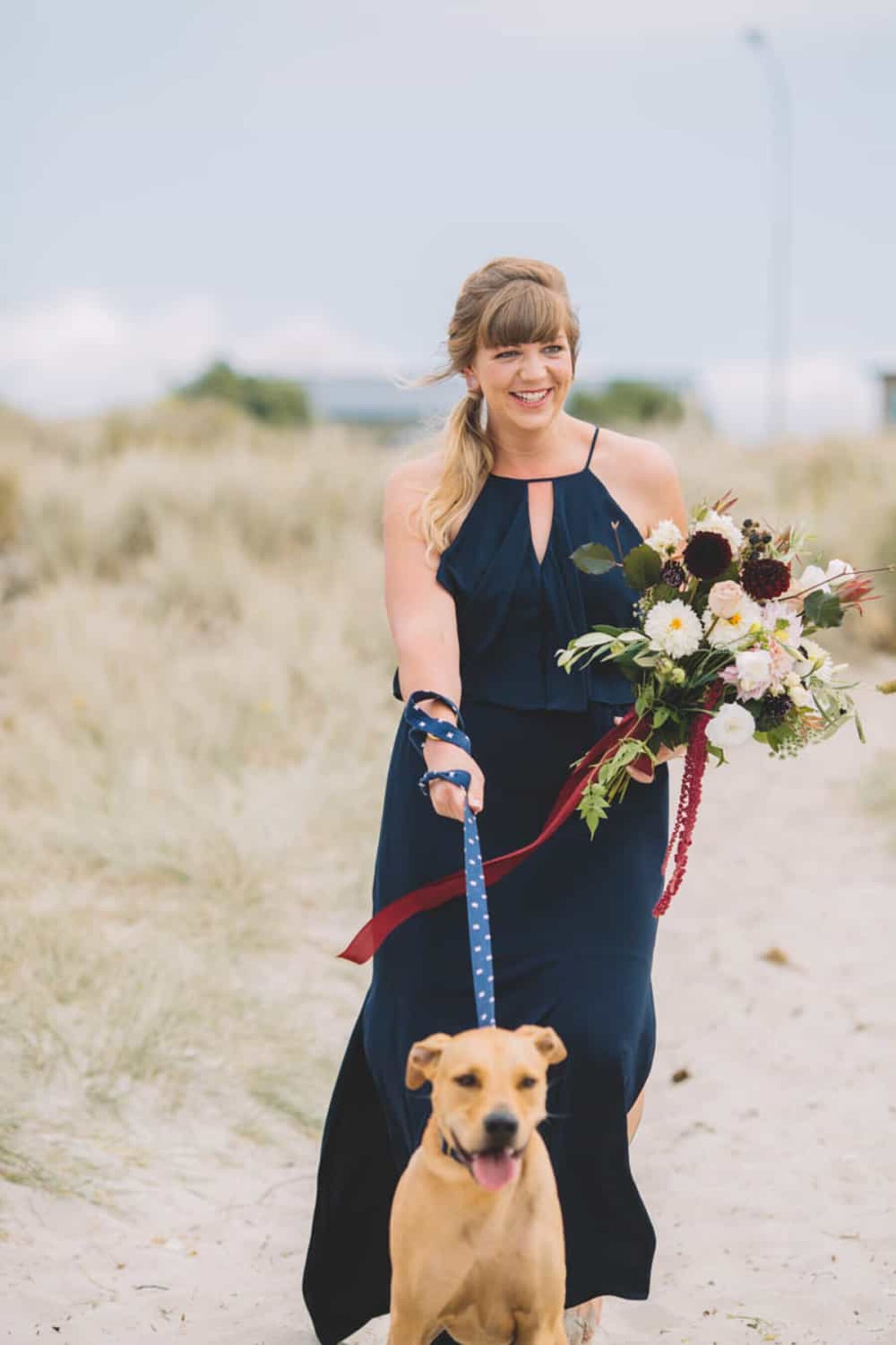 bridesmaid walking the aisle with dog