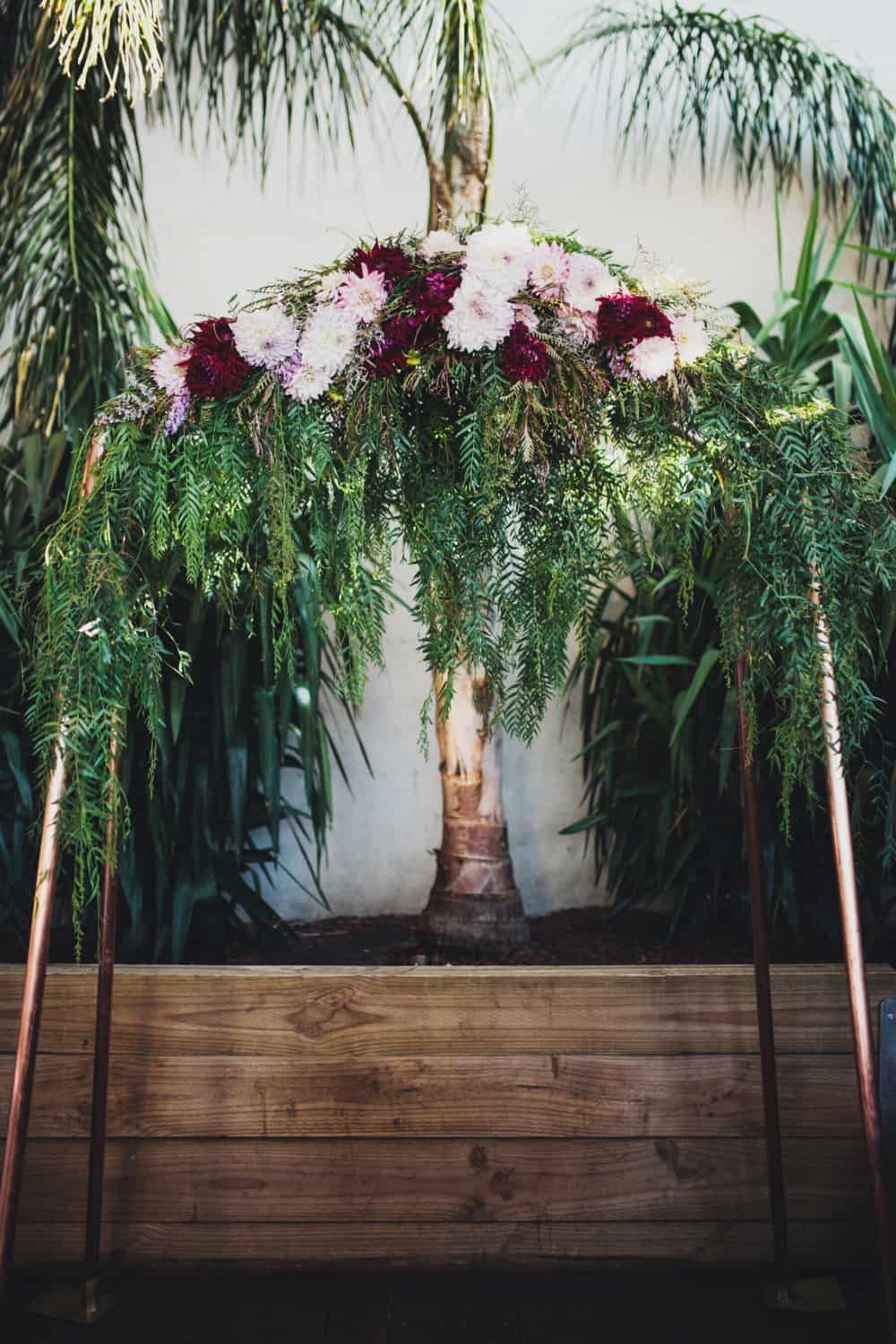 copper wedding arch with dahlias