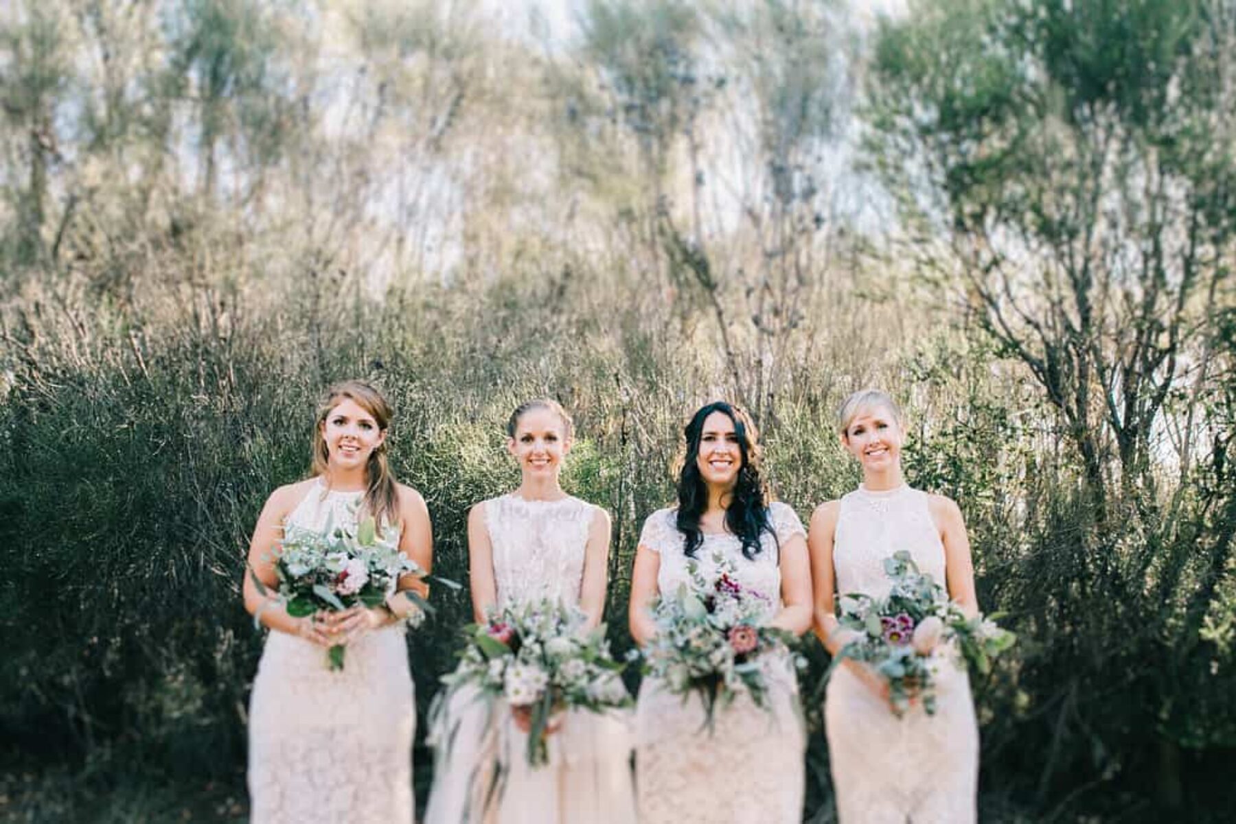 bridesmaids with native bouquets