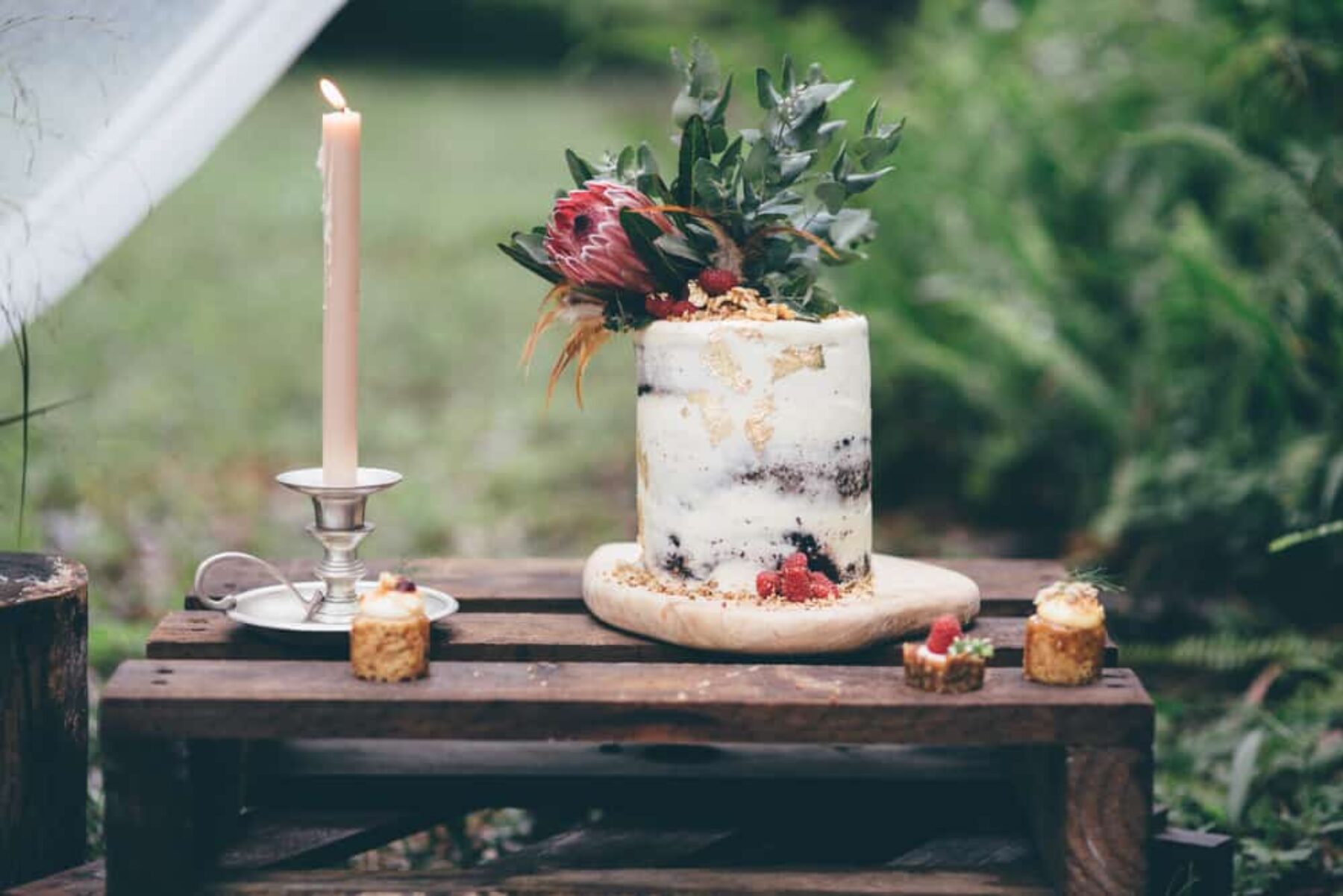 naked wedding cake with native flowers