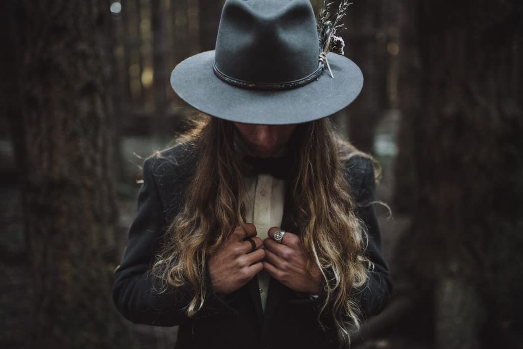 folky groom in feathered fedora