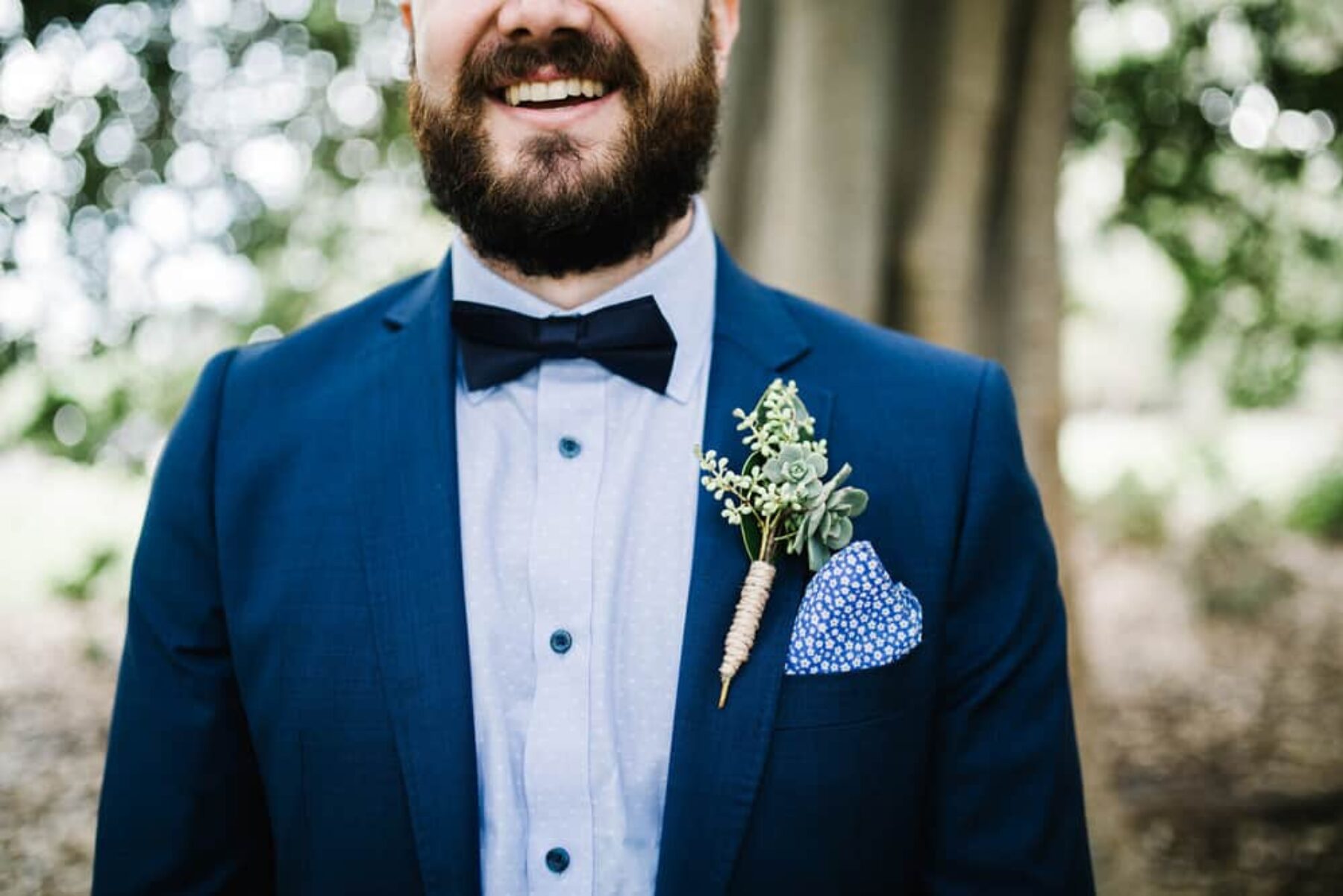 groom in cobalt suit with succulent boutonniere