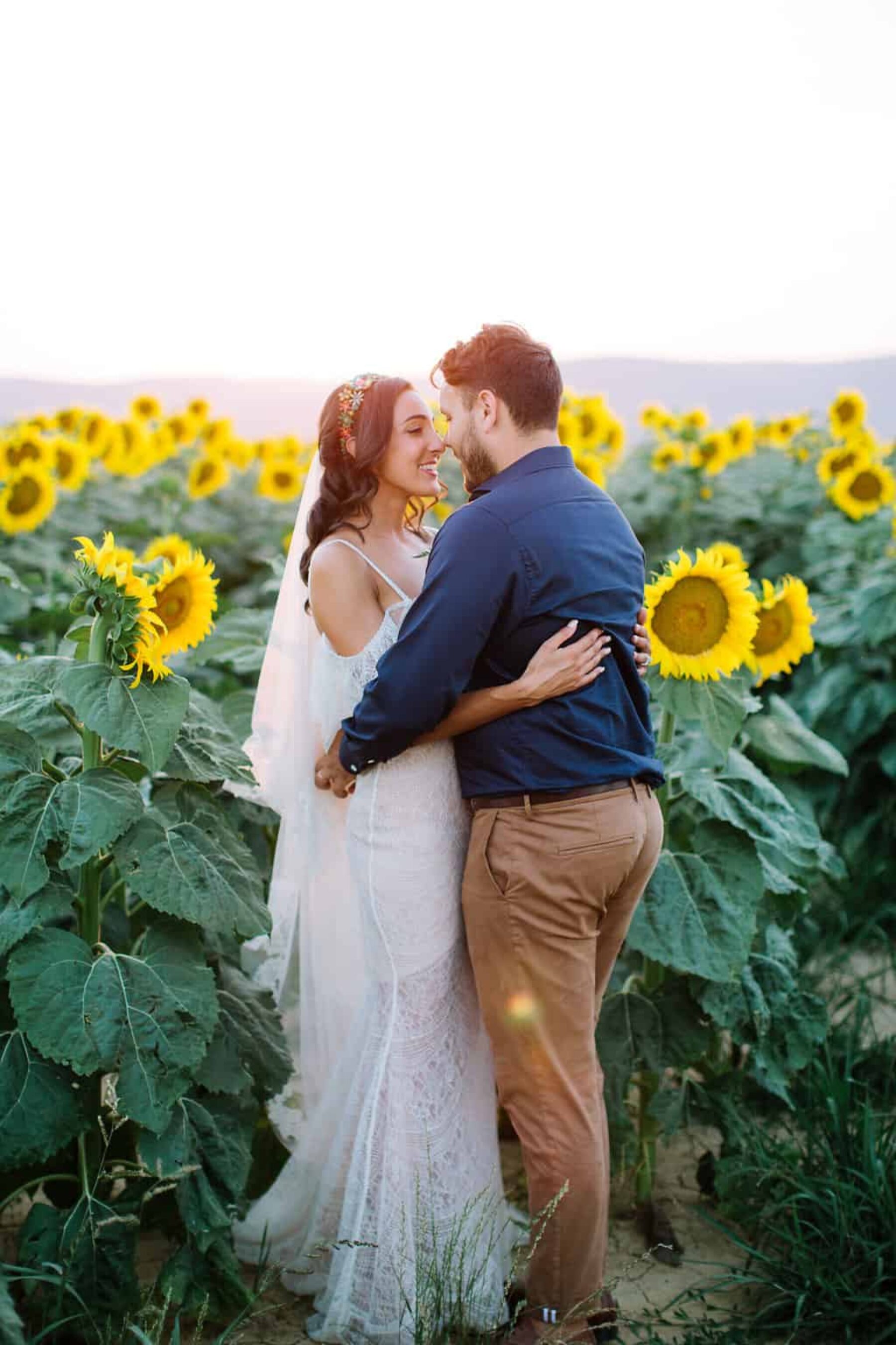 bride and groom in a sea of sunflowers in Tuscany