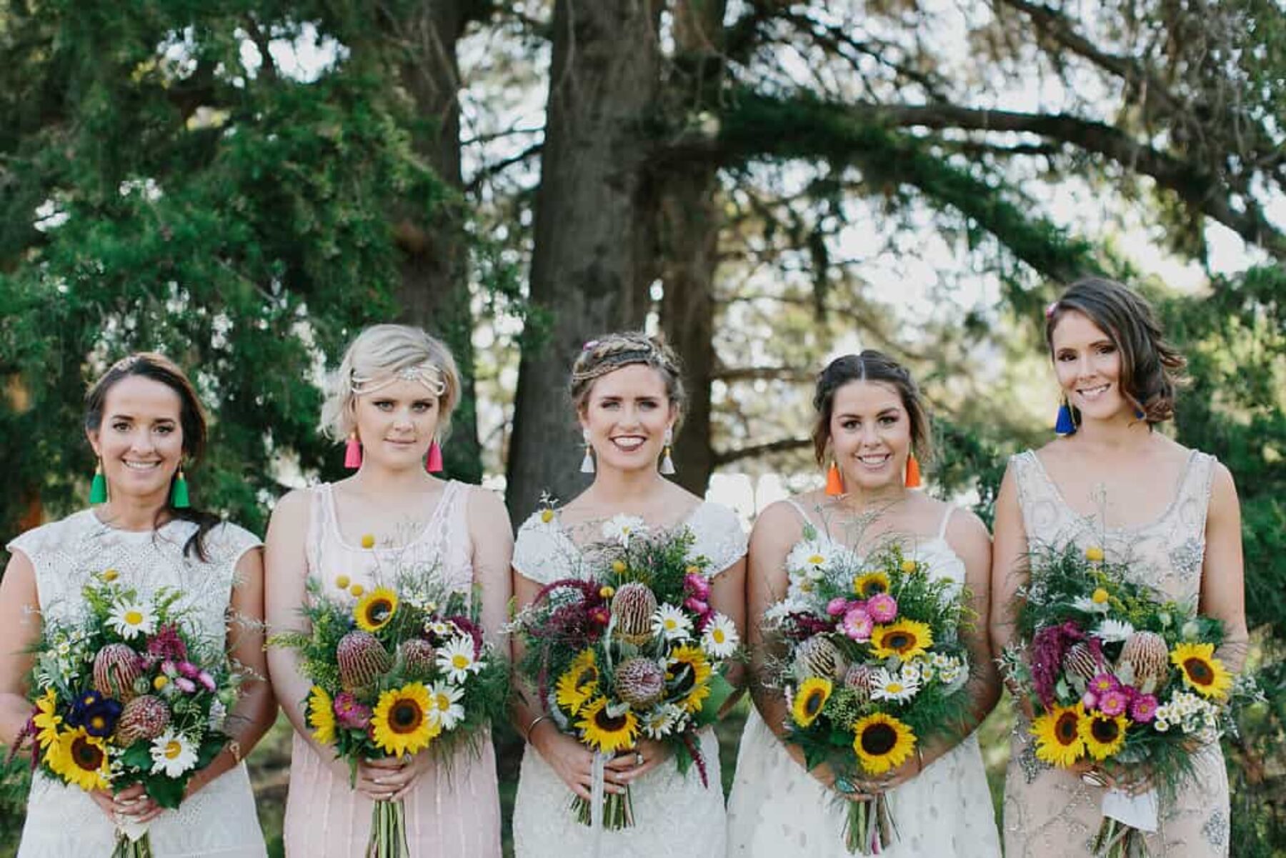 colourful bridesmaid bouquets with sunflowers, daisies and banksia