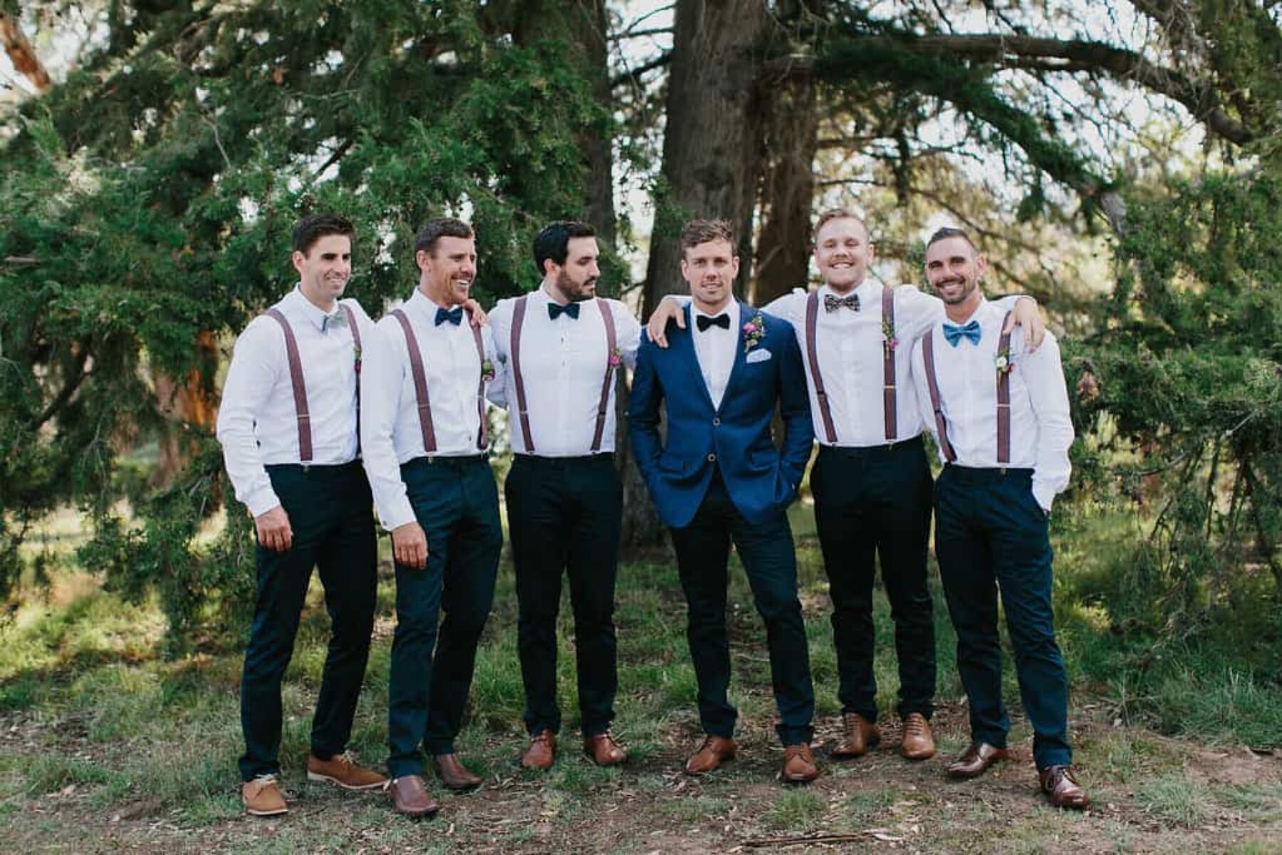 groomsmen in braces and bow ties