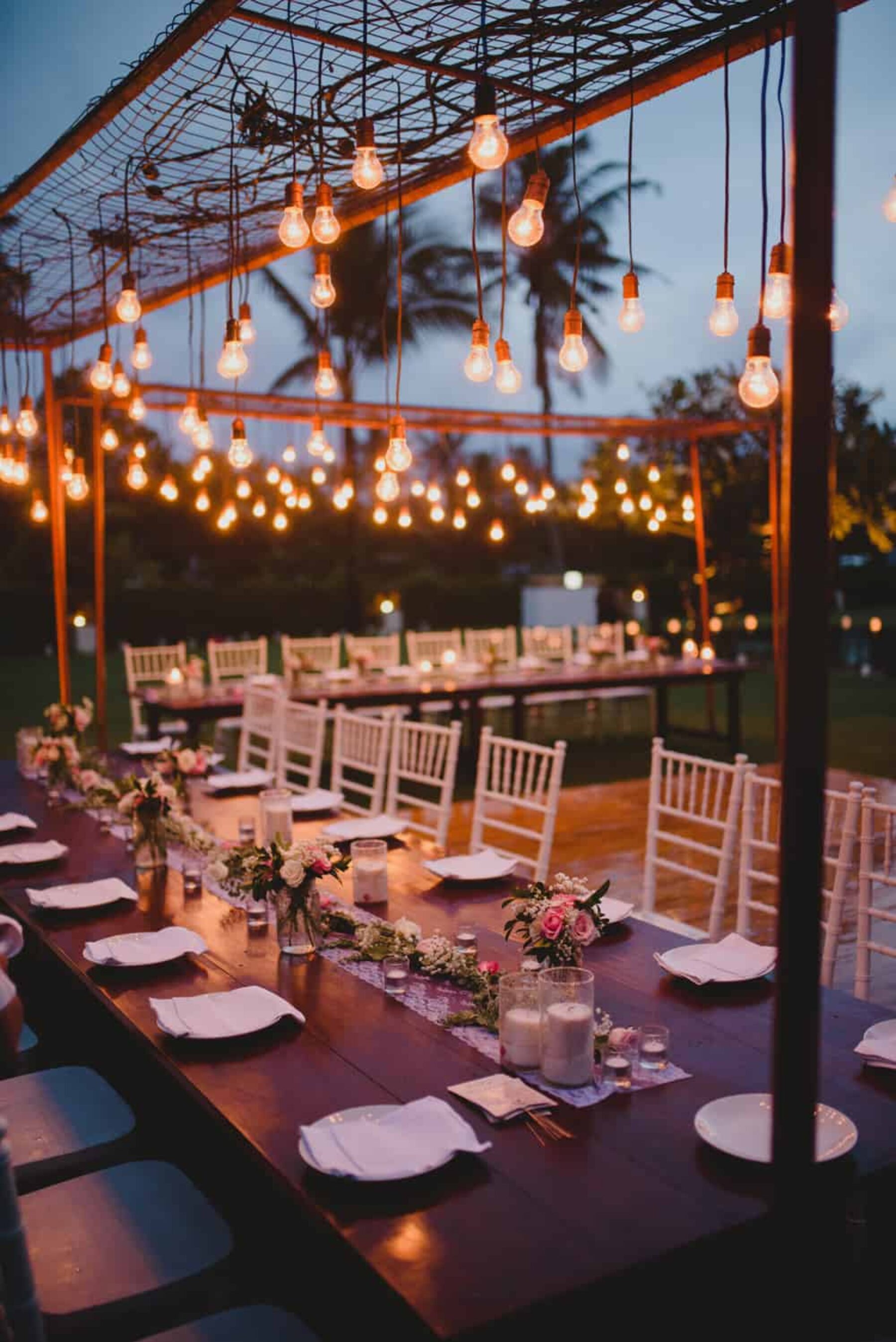 outdoor wedding table setting with hanging lights