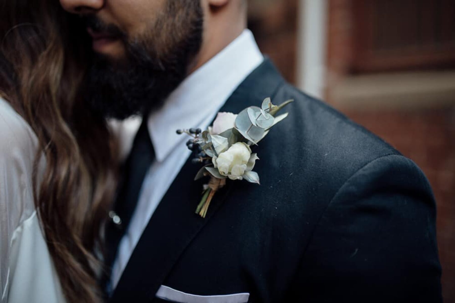 groom with native flower boutonniere