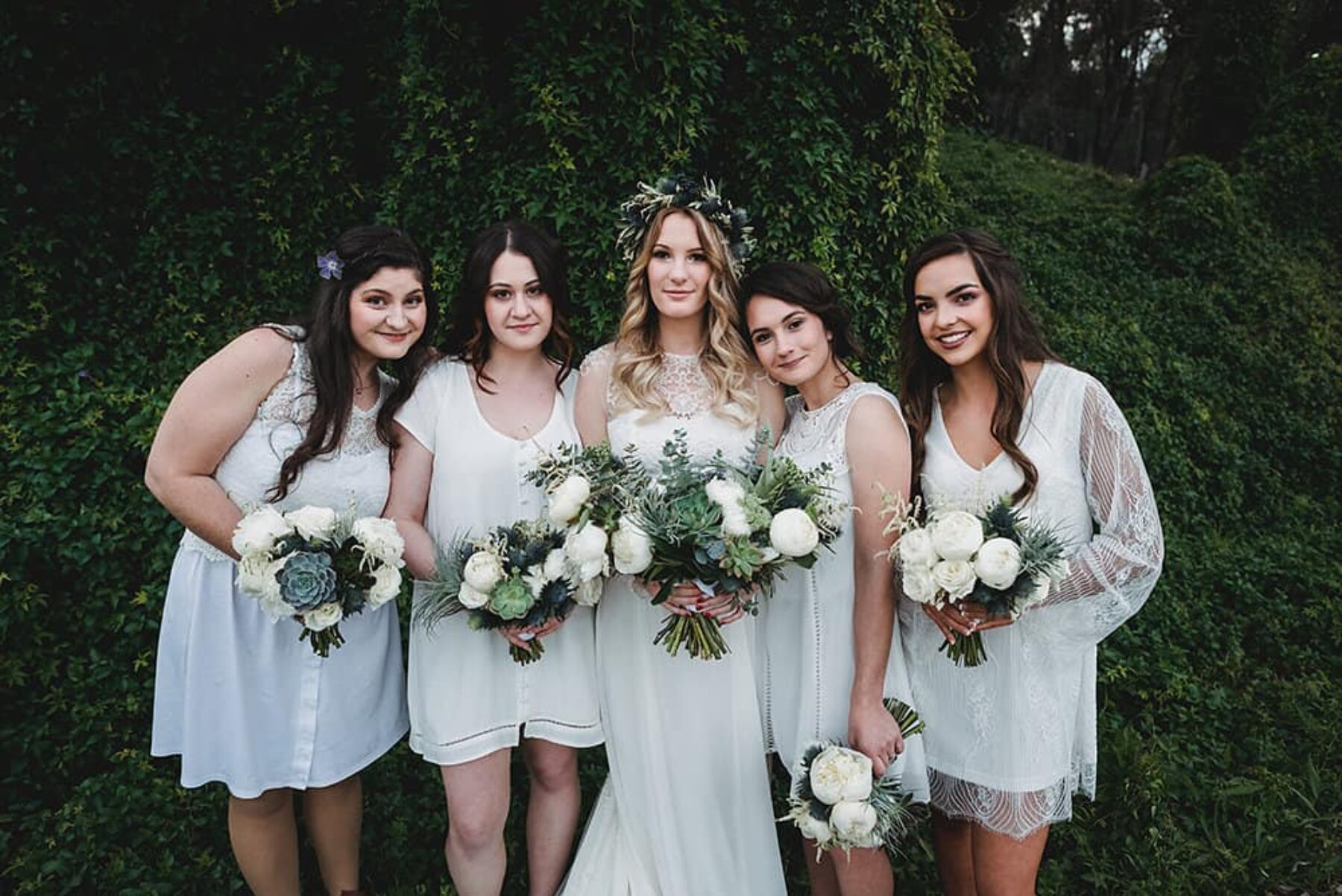 bridesmaids in mismatching white dresses