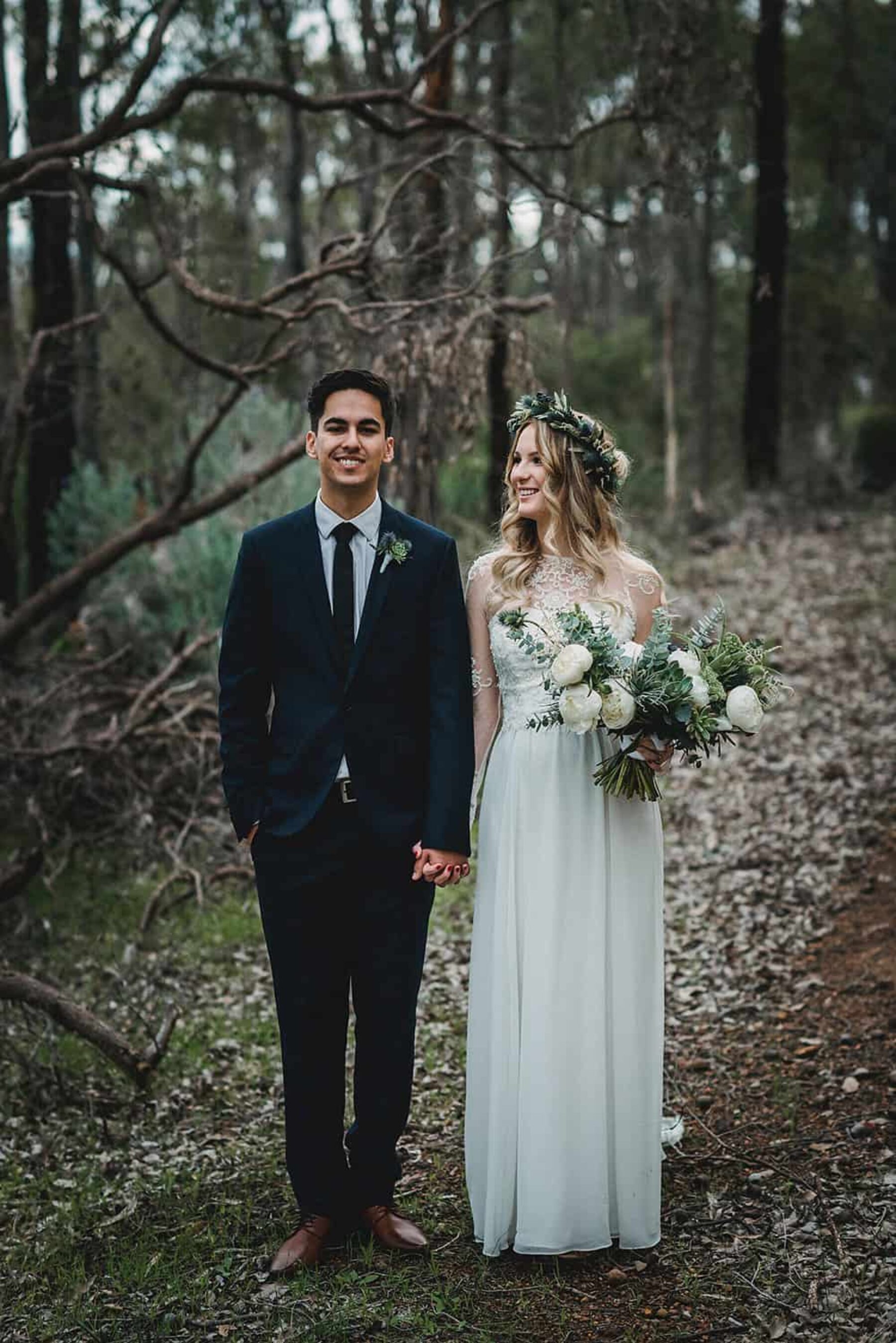 boho bride and groom with green and white bouquet