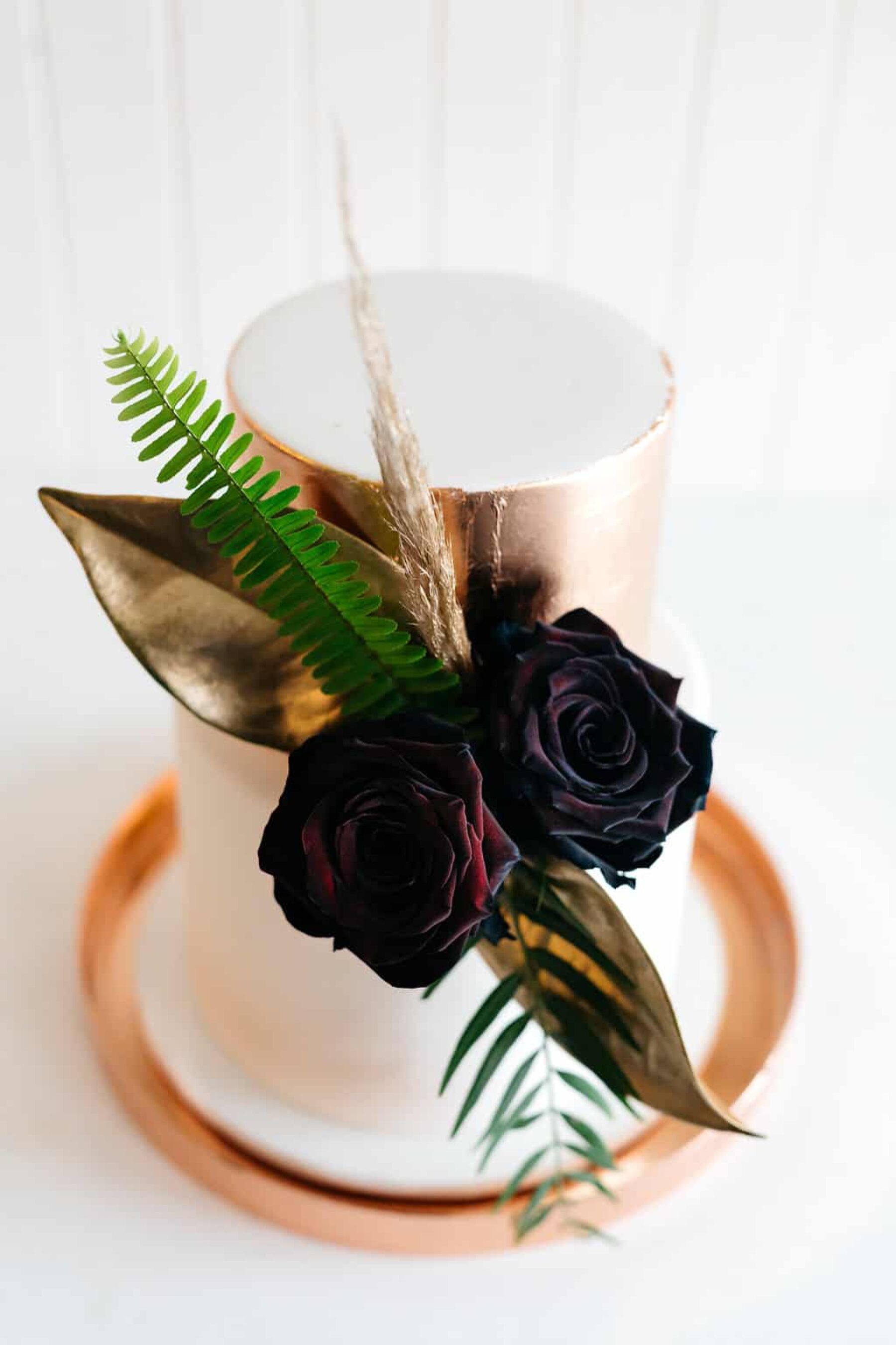 modern metallic wedding cake with black roses