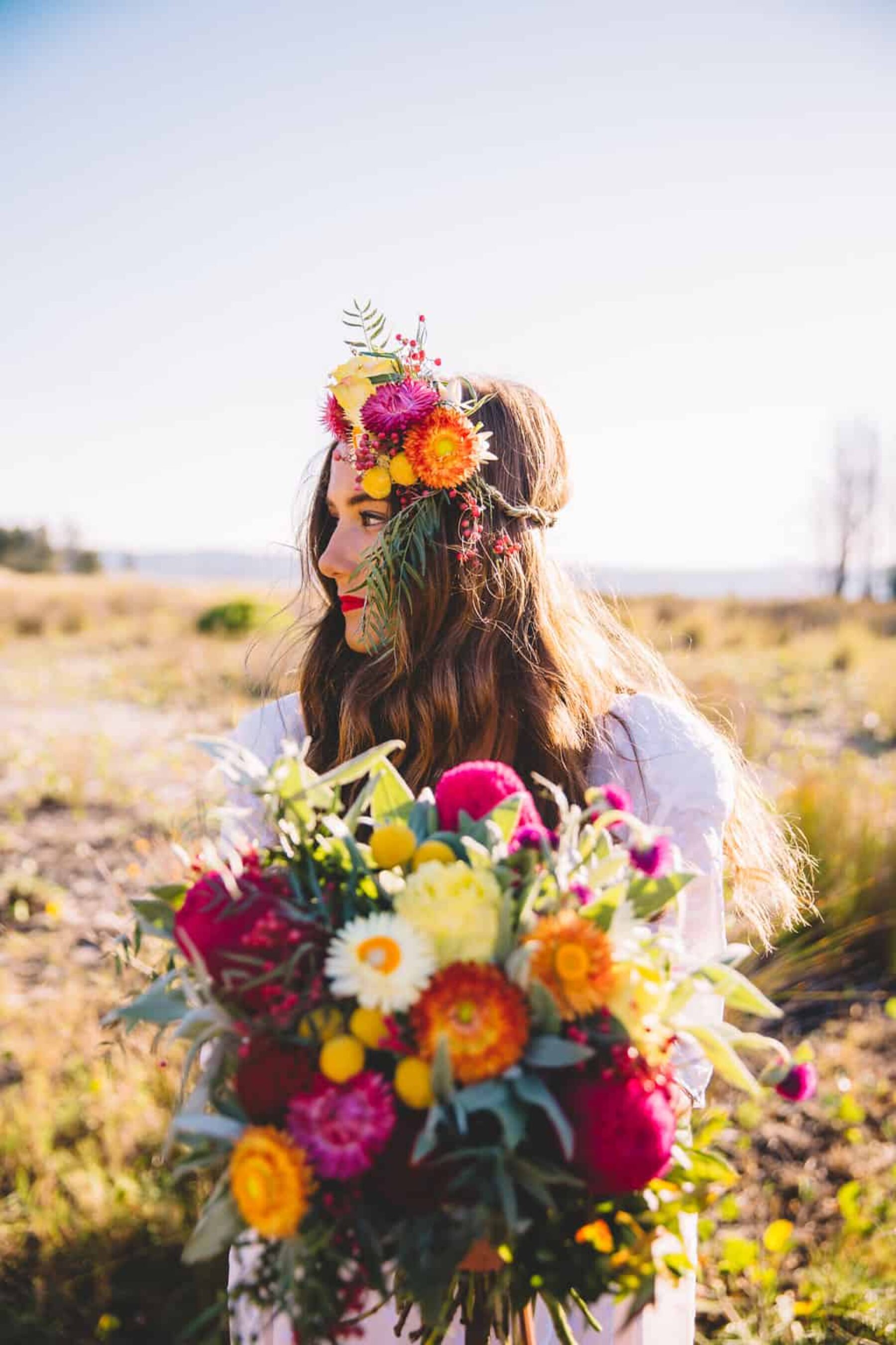 boho bride with colourful flower crown and bouquet