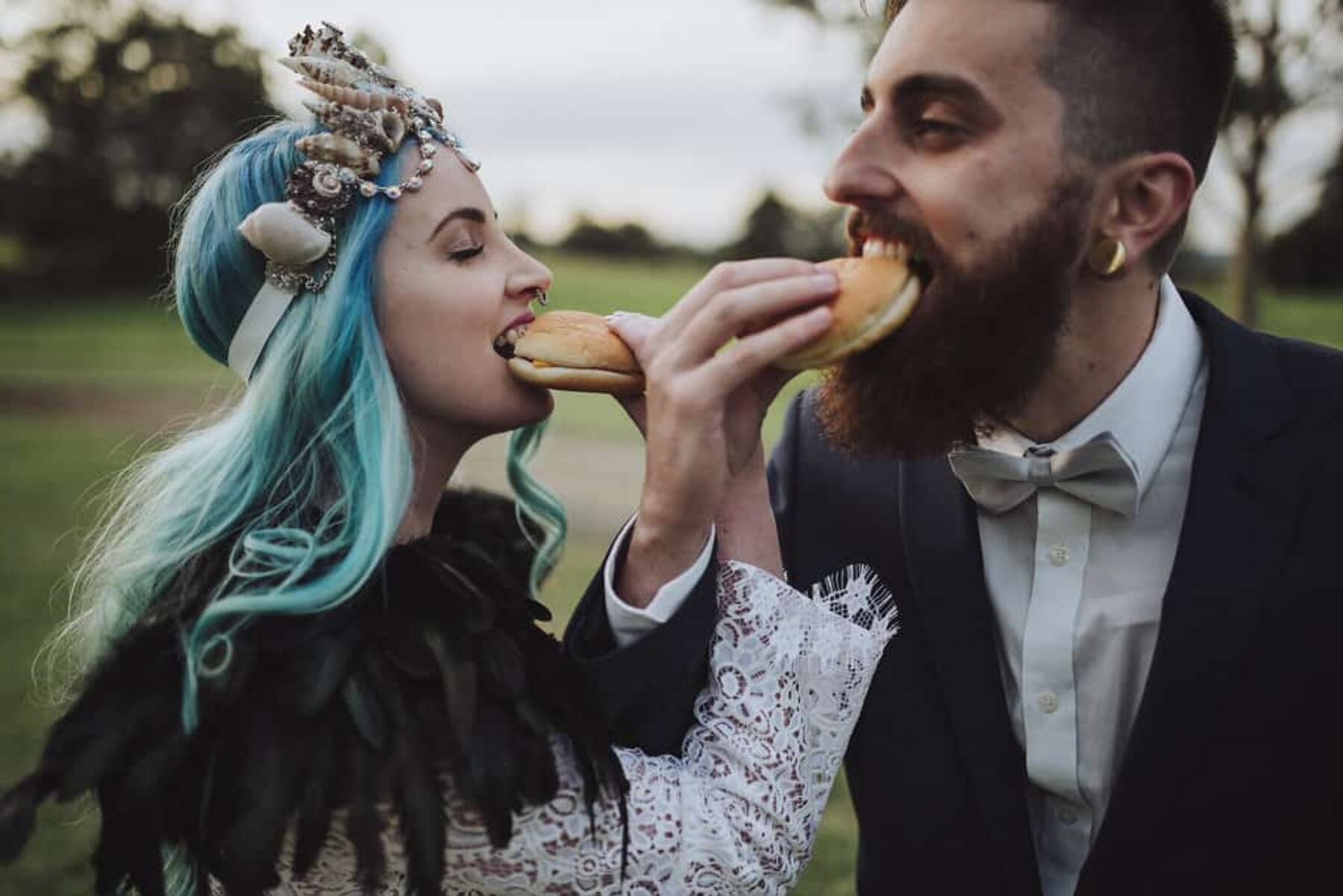 hipster bride and groom eating cheeseburgers