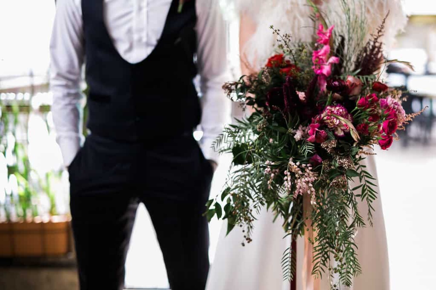 cool bride and groom with oversize bouquet