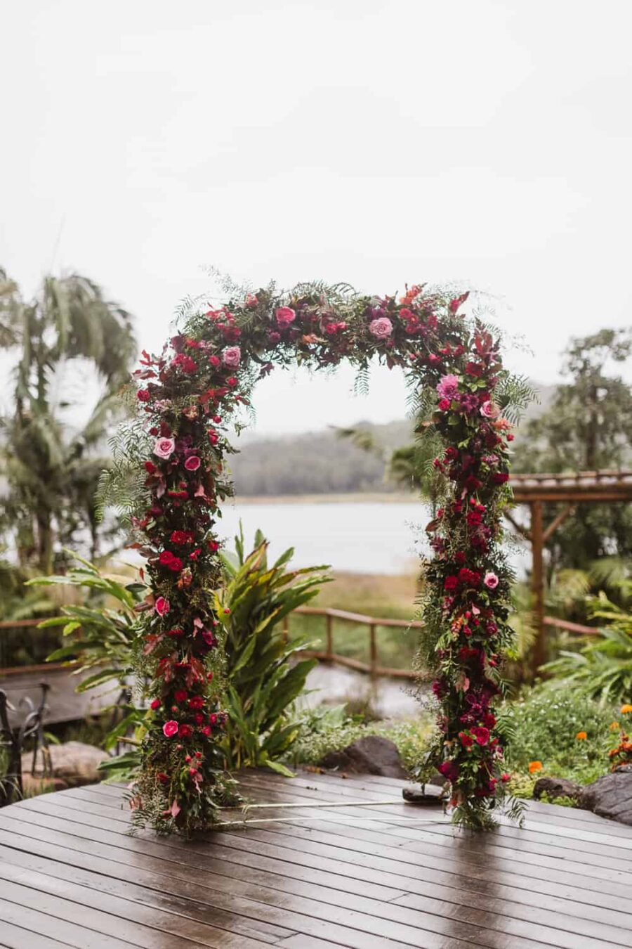 berry-toned floral wedding arch