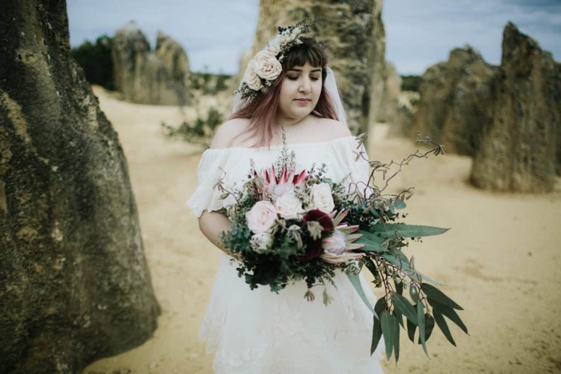 boho bride with king protea bouquet