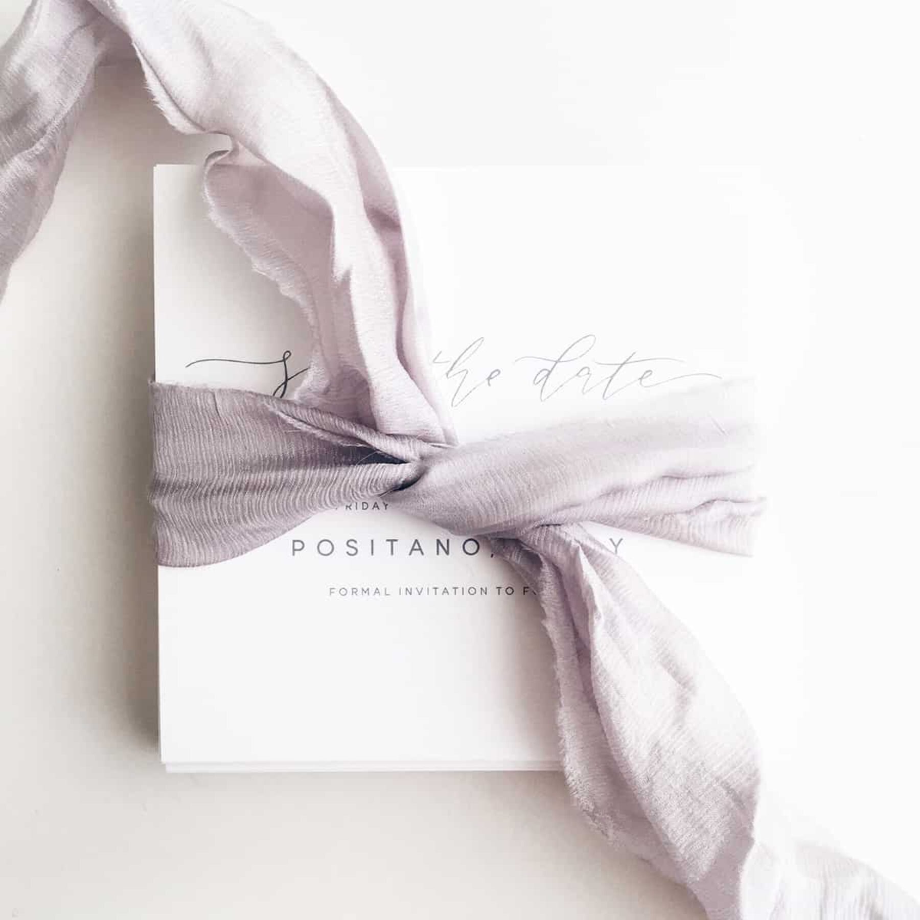 ribbon-bound wedding stationery by Paige Tuzee