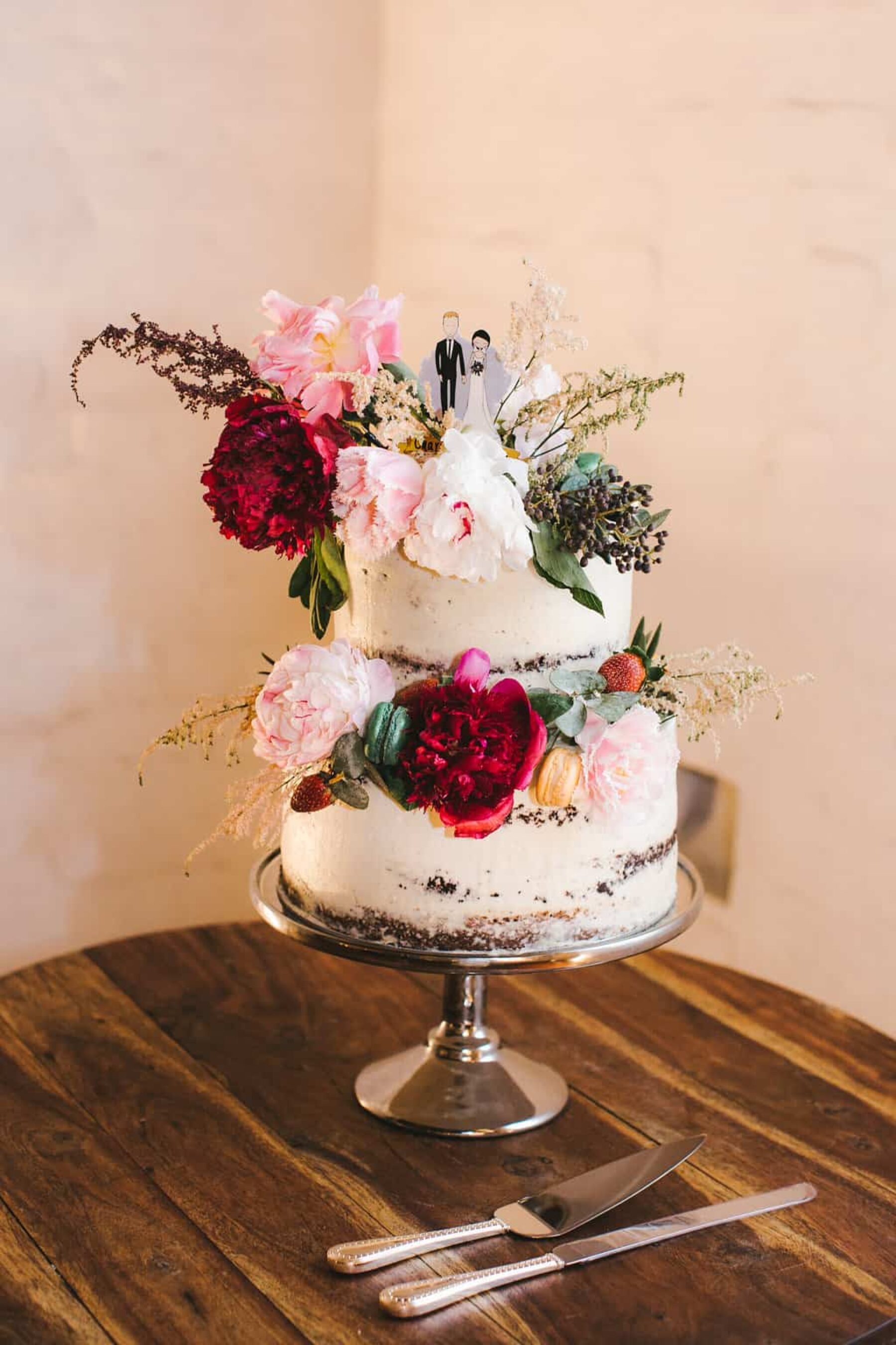 simple two-tiered wedding cake with fresh flowers