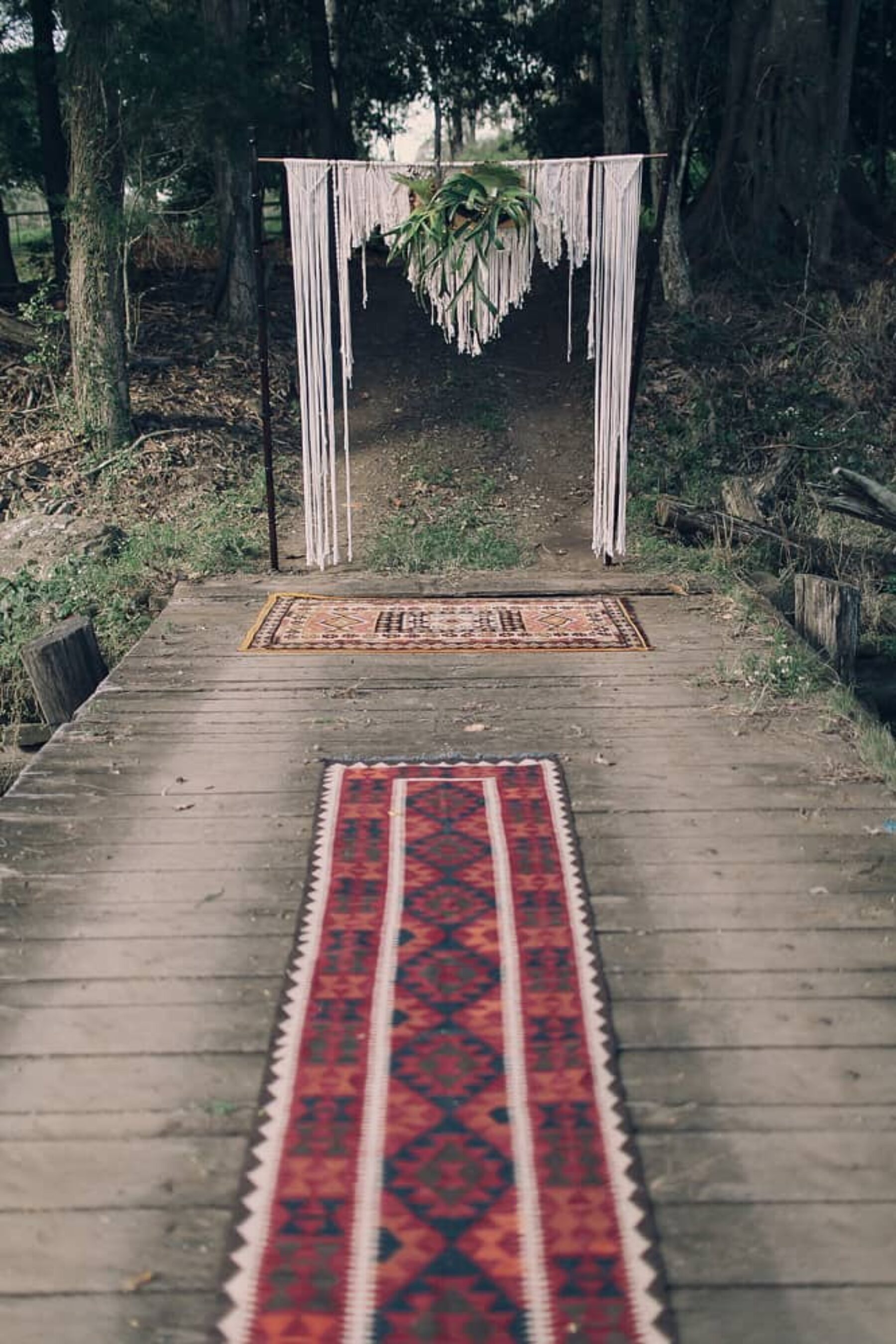 Persian rug aisle and macrame wedding backdrop