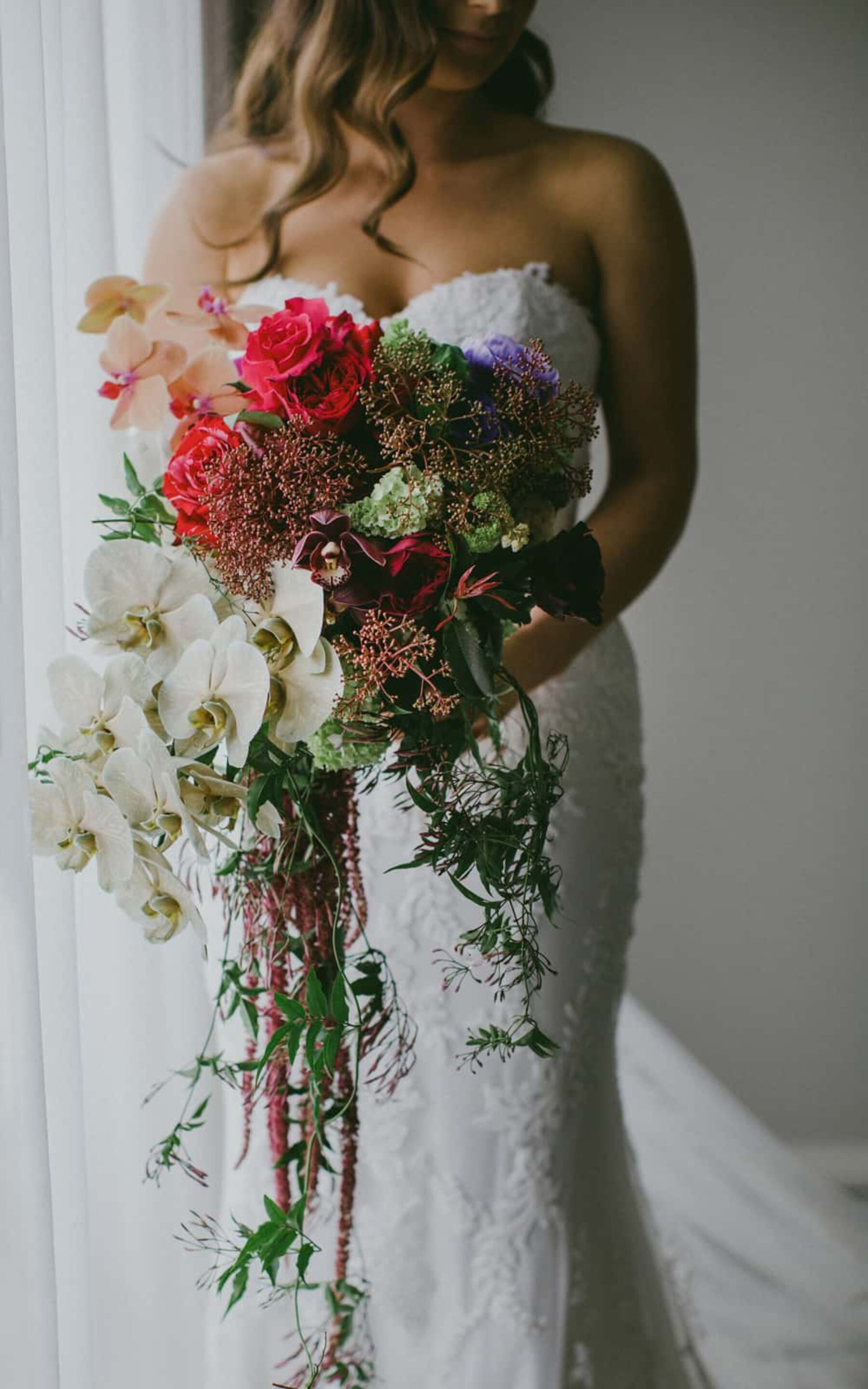 unstructured bridal bouquet with orchids and amaranth