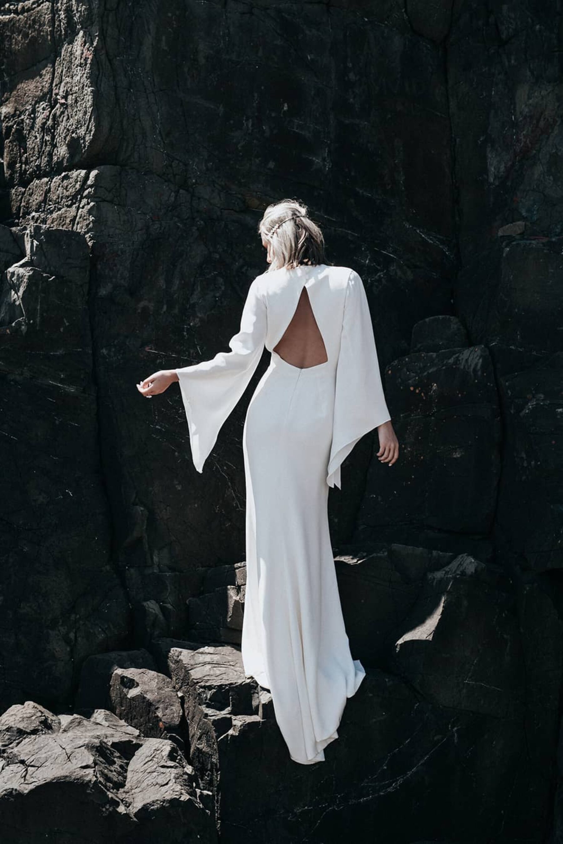 modern backless wedding dress with bell sleeves