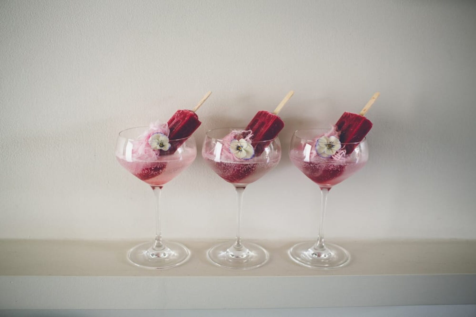 modern cocktails with popsicles and edible flowers