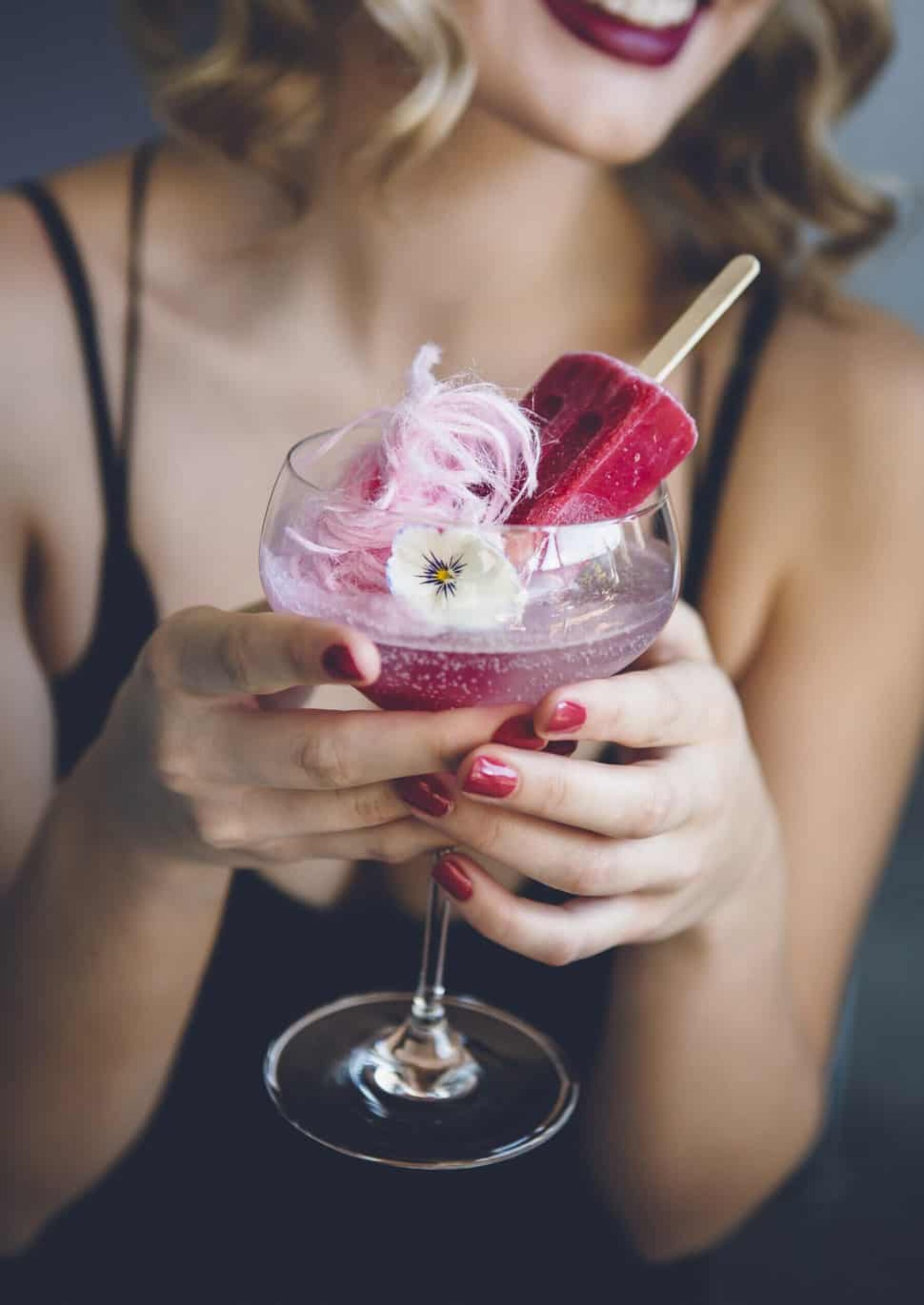 modern cocktail with candy floss, popsicles and edible flowers