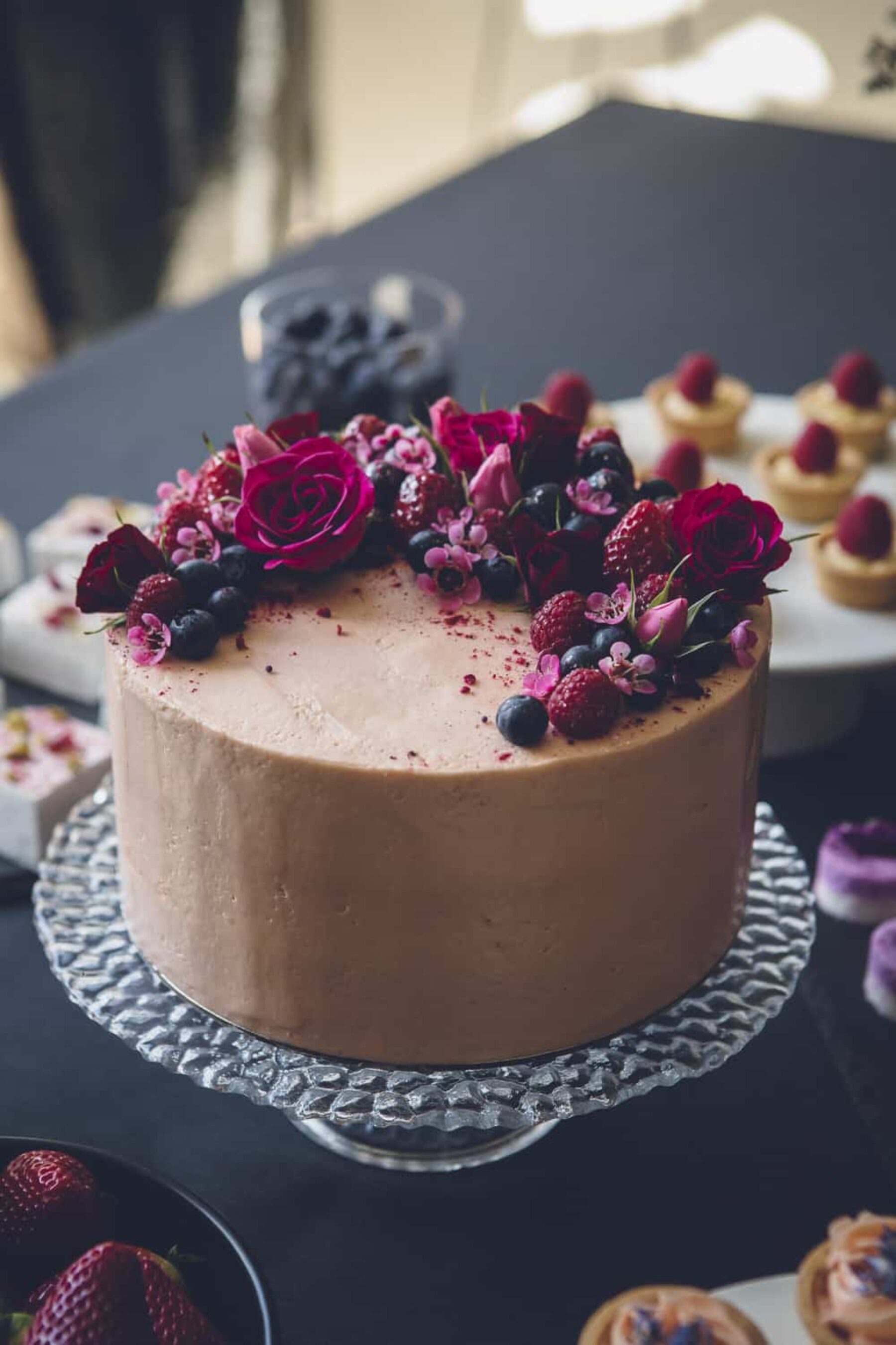 simple chocolate cake with berries and fresh flowers