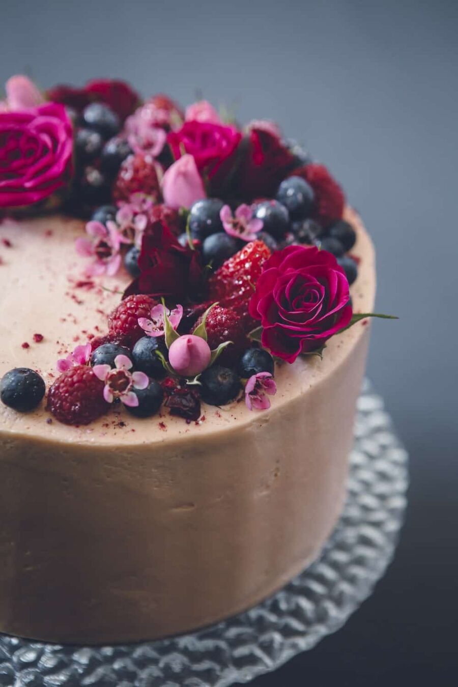 simple chocolate cake with berries and fresh flowers