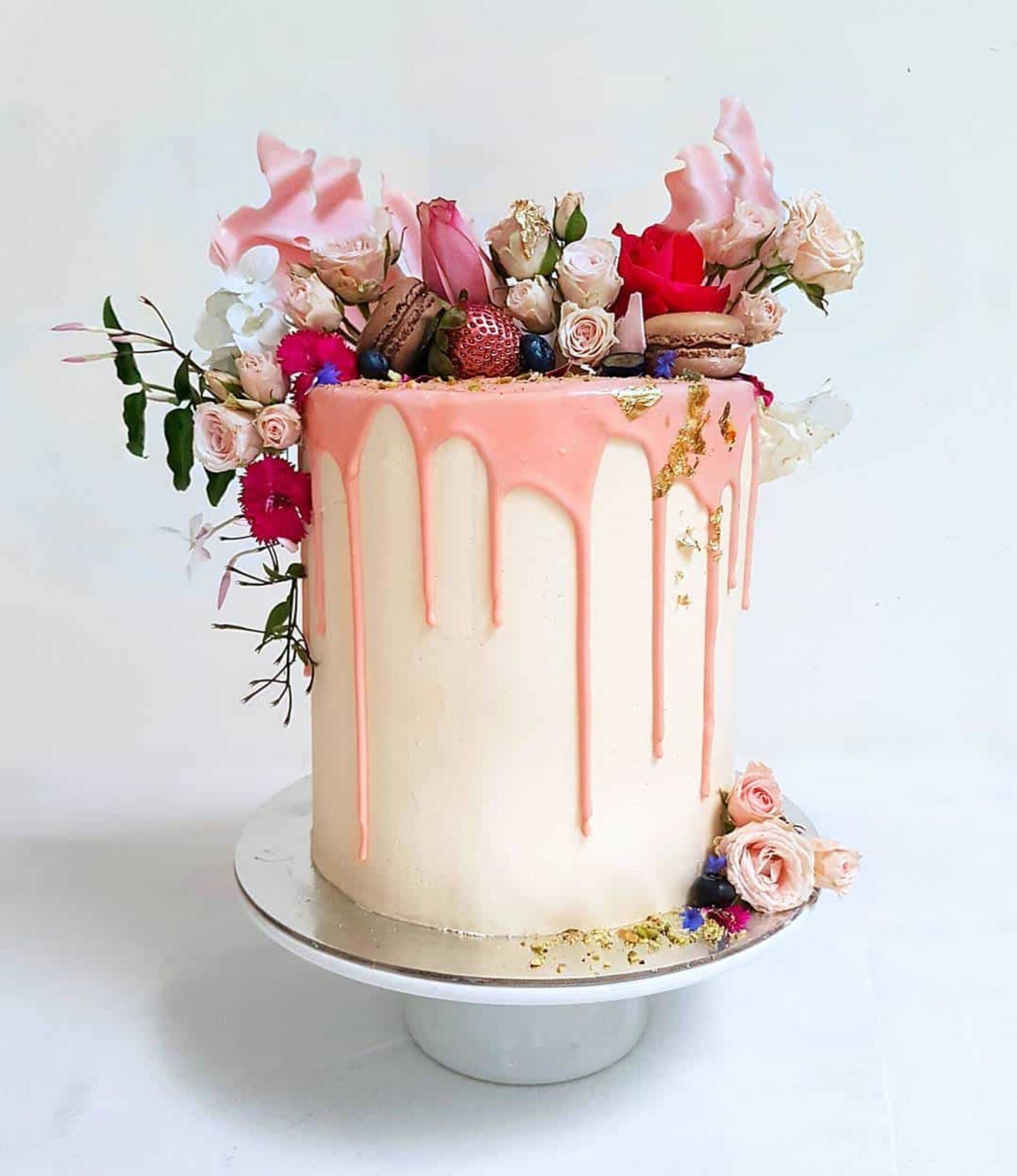 modern createive wedding cake with pink drip icing