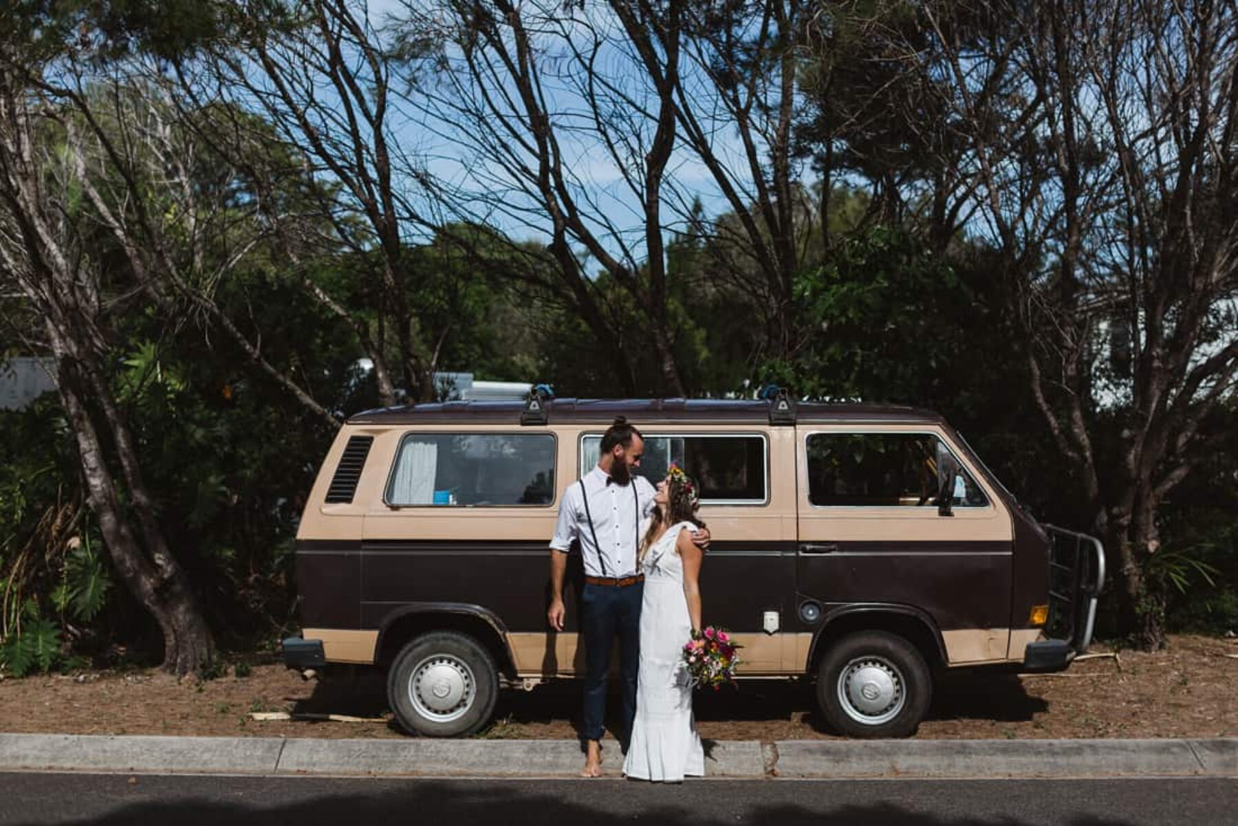 bride and grrom with vintage camper van
