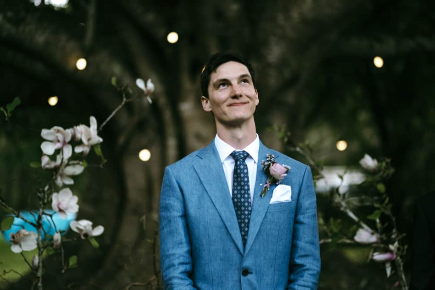 Stylish groom in blue suit by Oscacr Hunt
