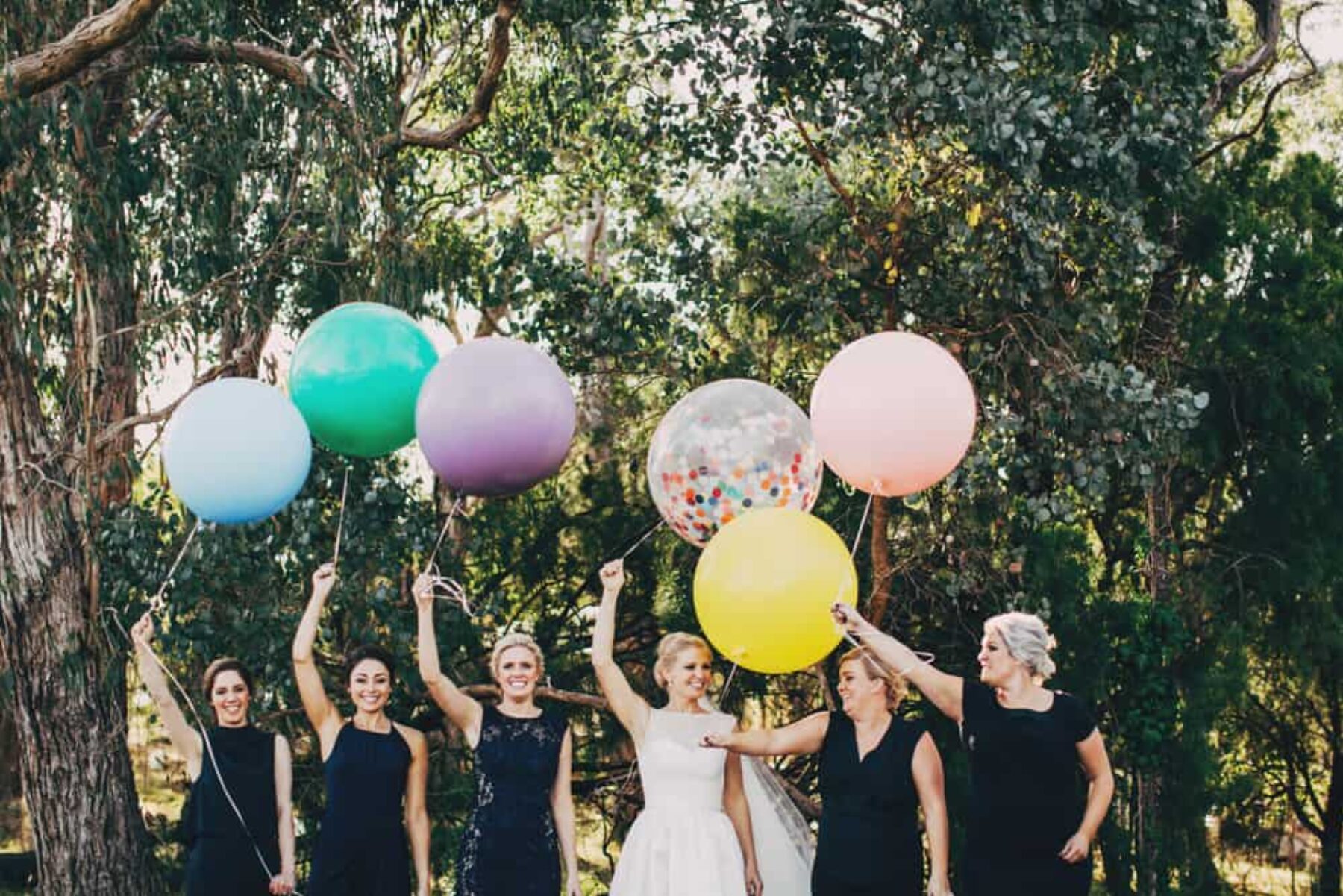 bride and bridesmaids with giant colour balloons