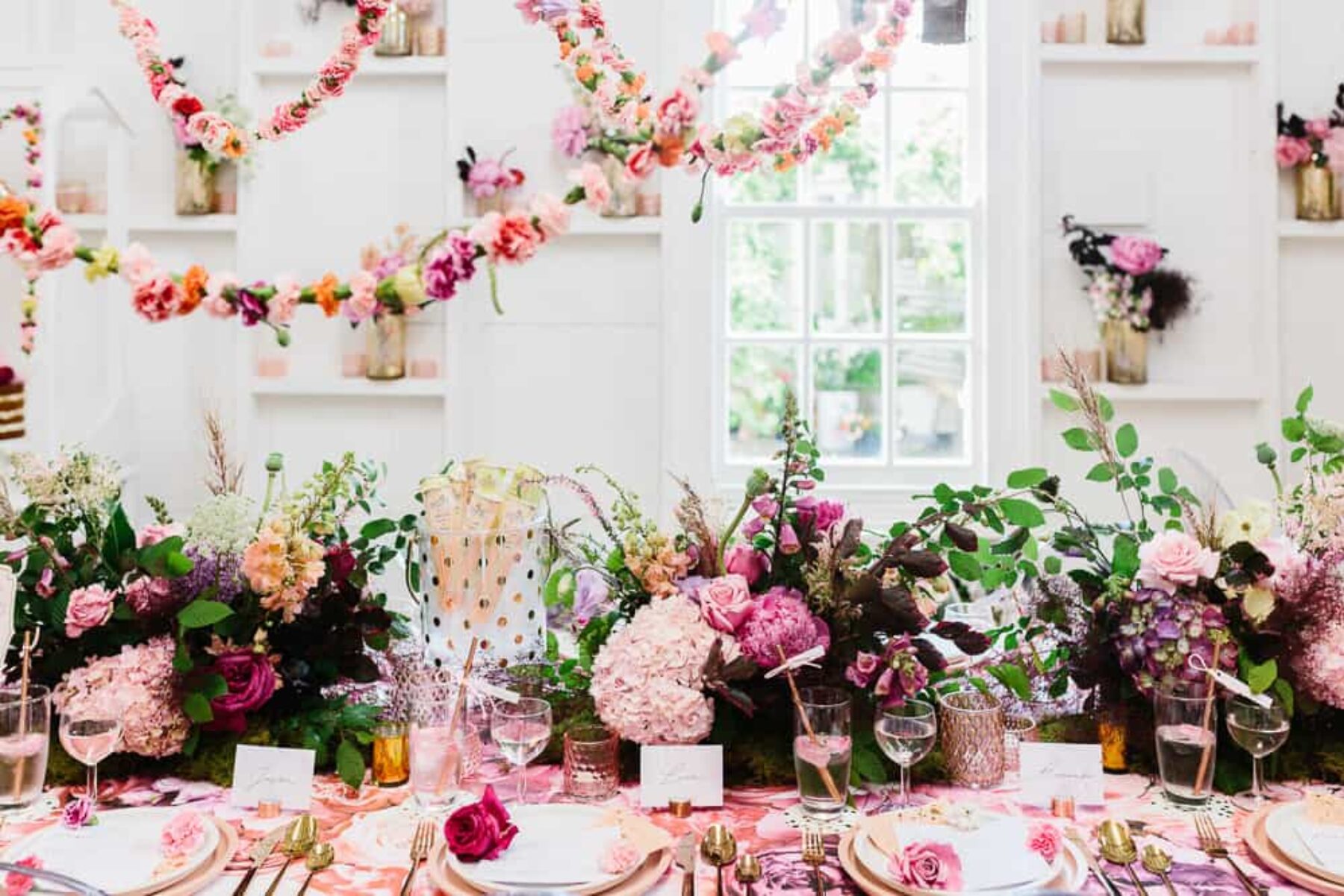 Floral tablescape with hanging floral garlands