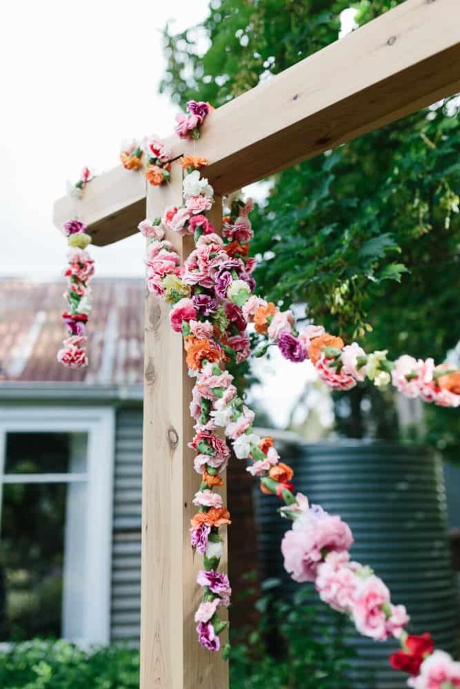 timber wedding arch with floral garlands
