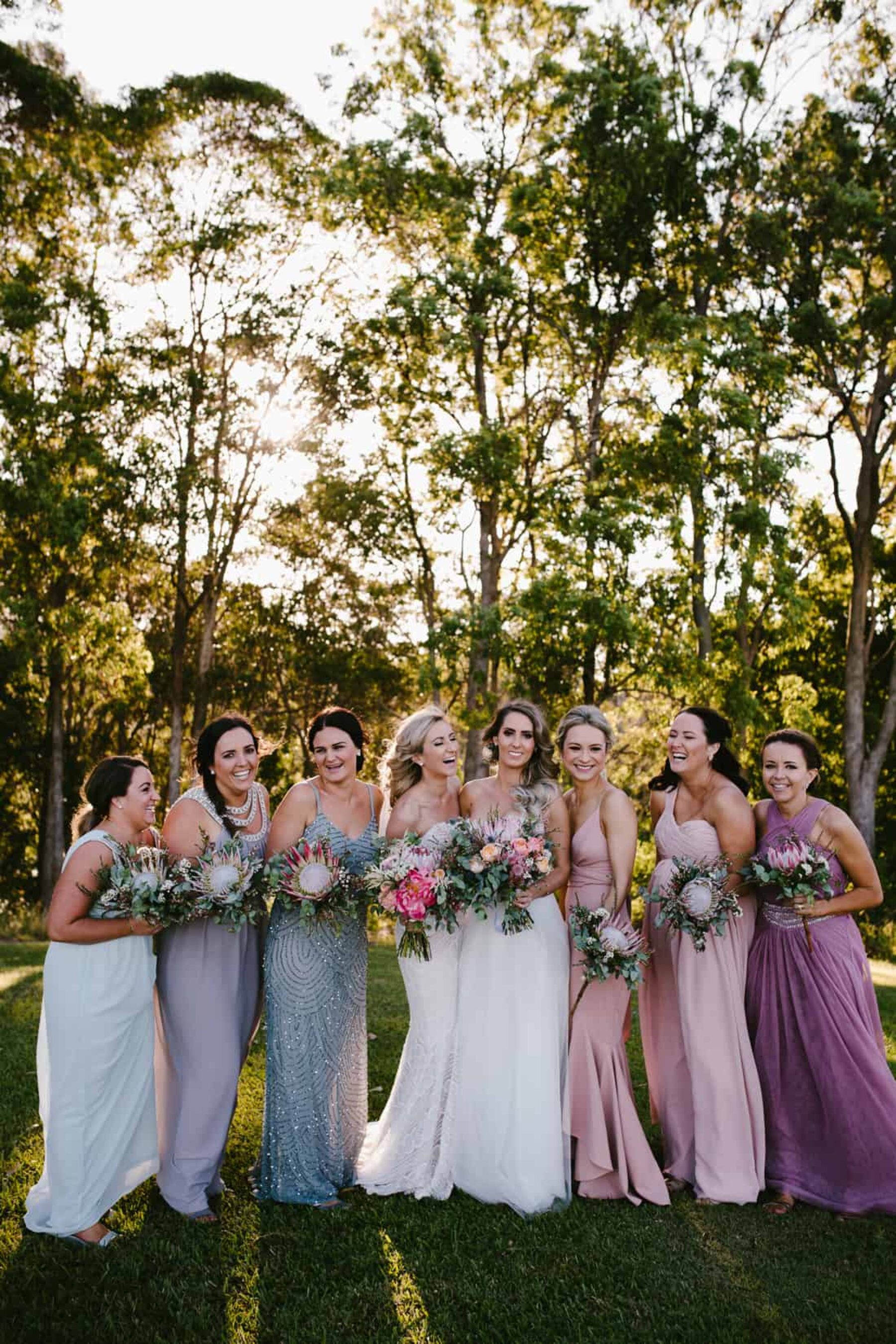 brides and bridesmaids with protea bouquets