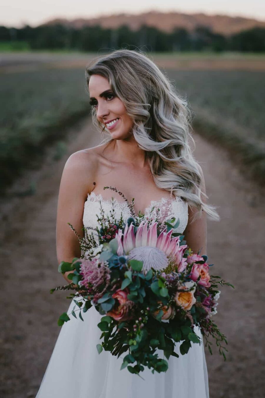 gorgeous bride with protea bouquets
