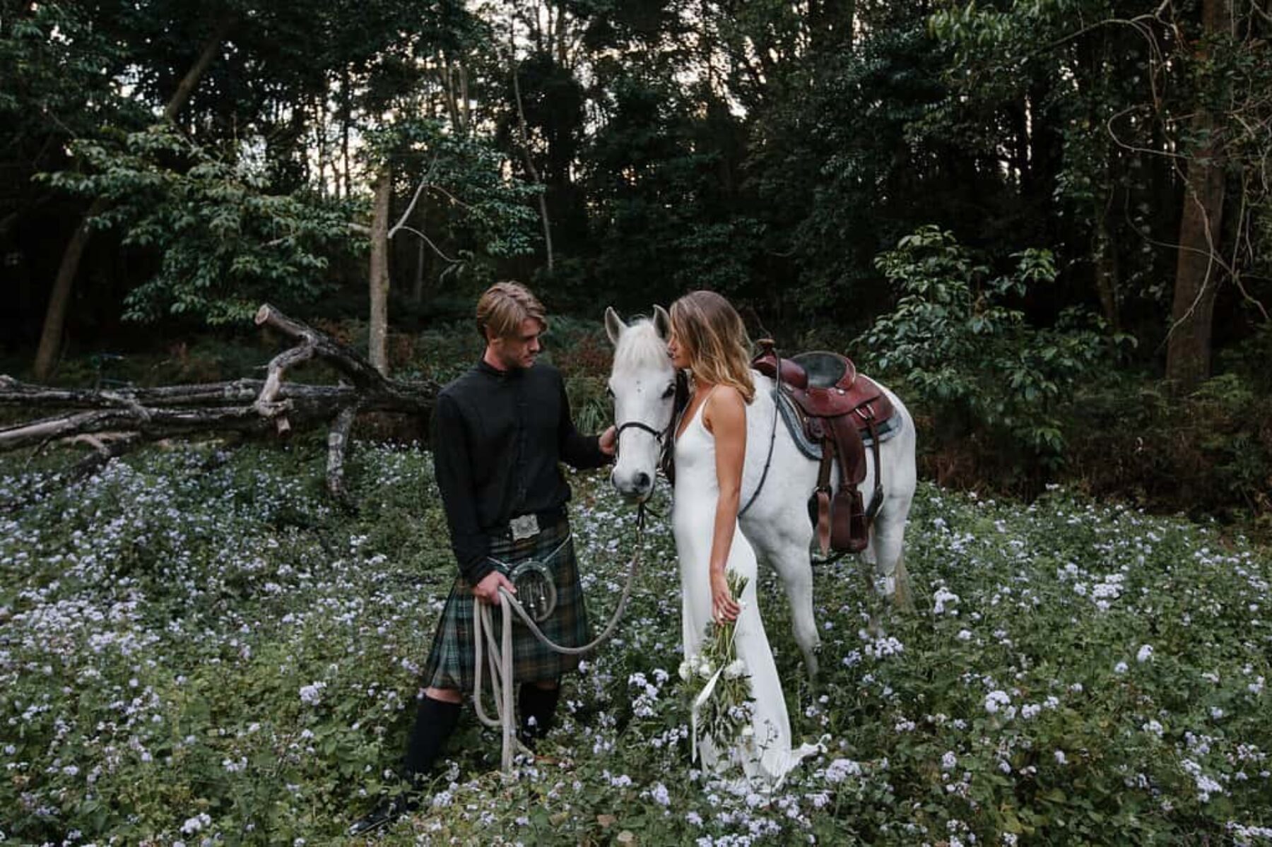 boho bride and groom with white horse