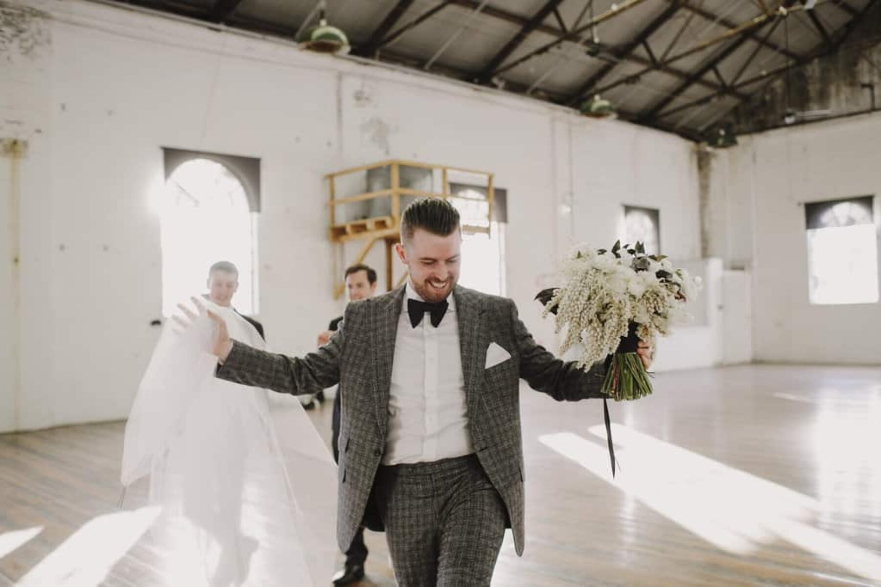 stylish groom with bouquet