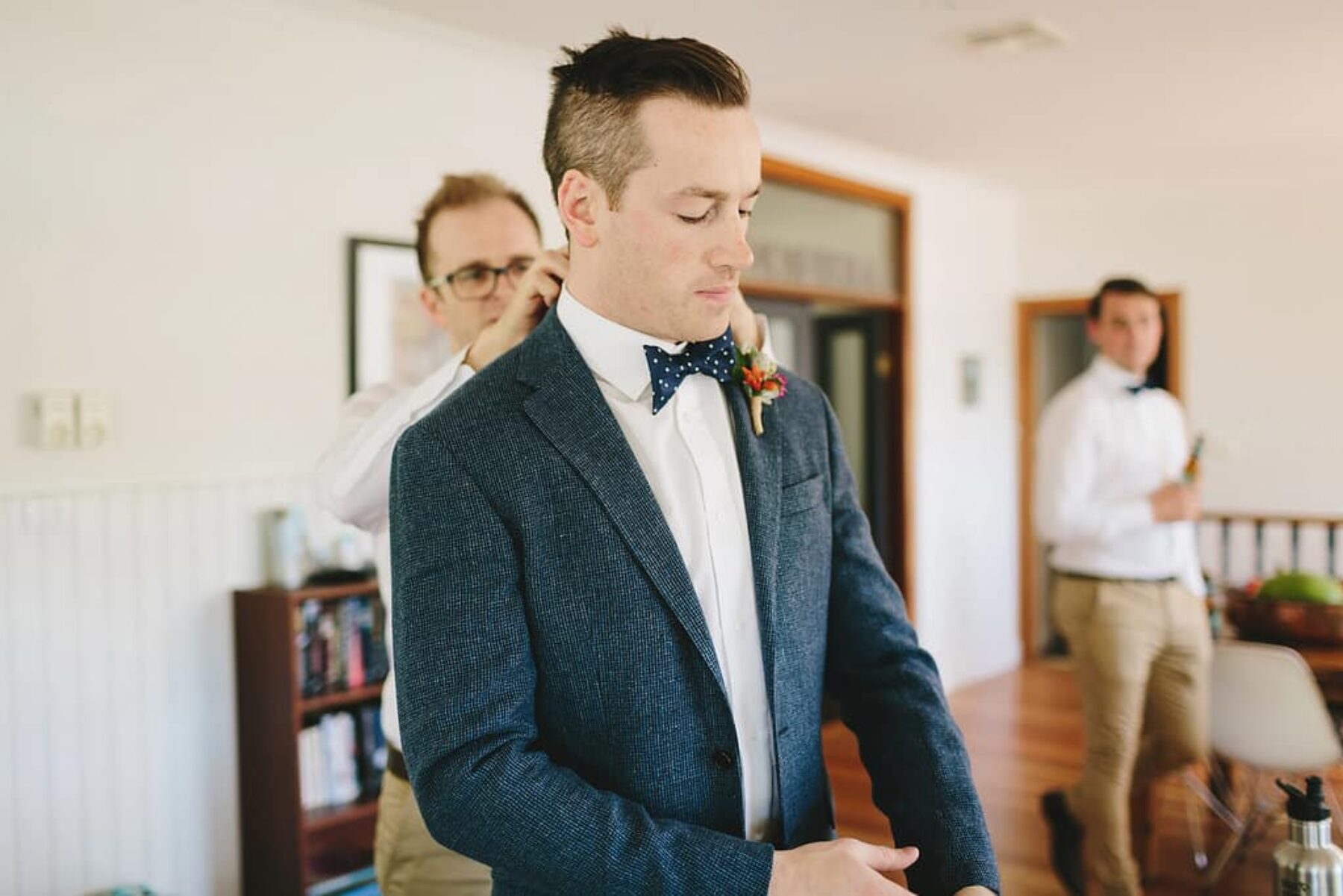 dapper groom with polka dot bow tie