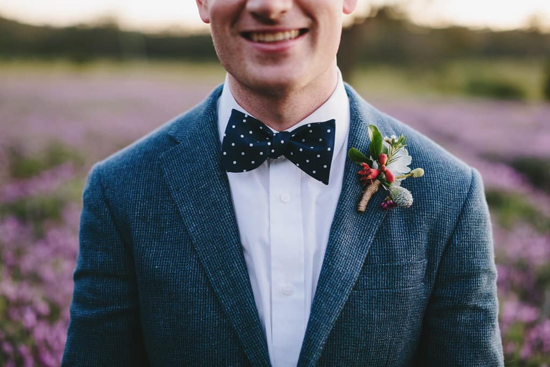 groom in tweed blazer and bow tie