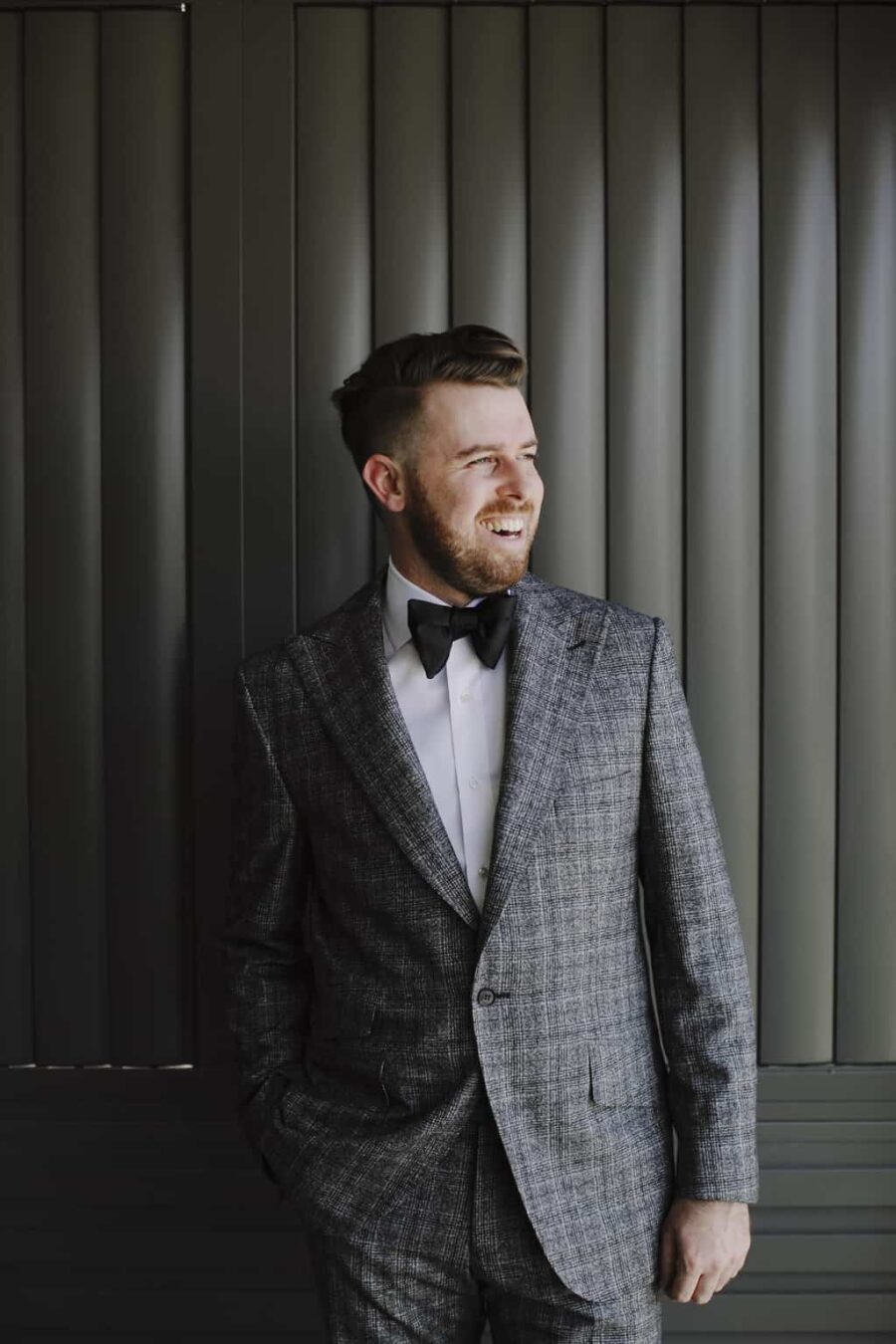 stylish groom in check suit and double bow tie
