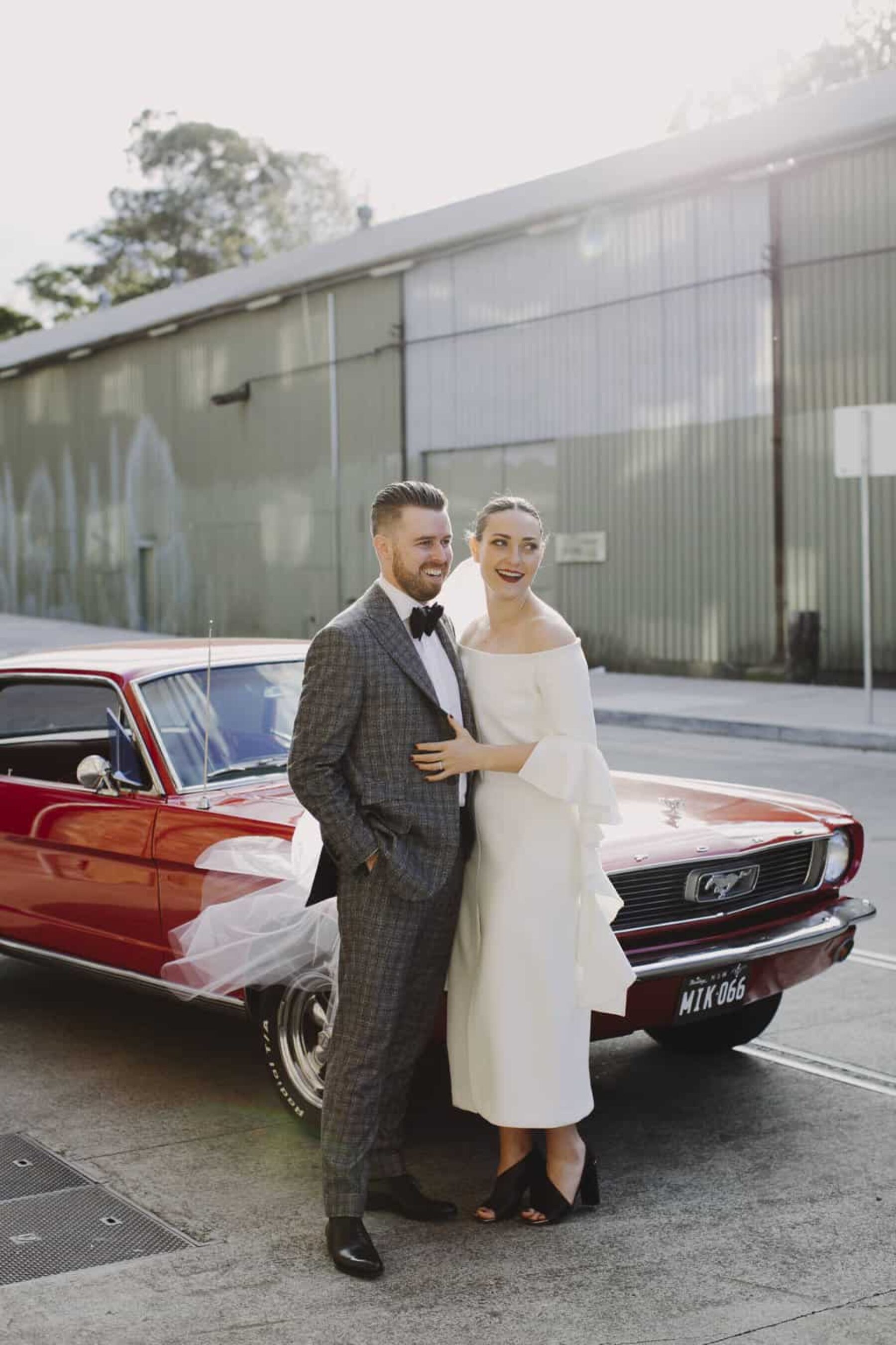 modern bride and groom with vintage wedding car