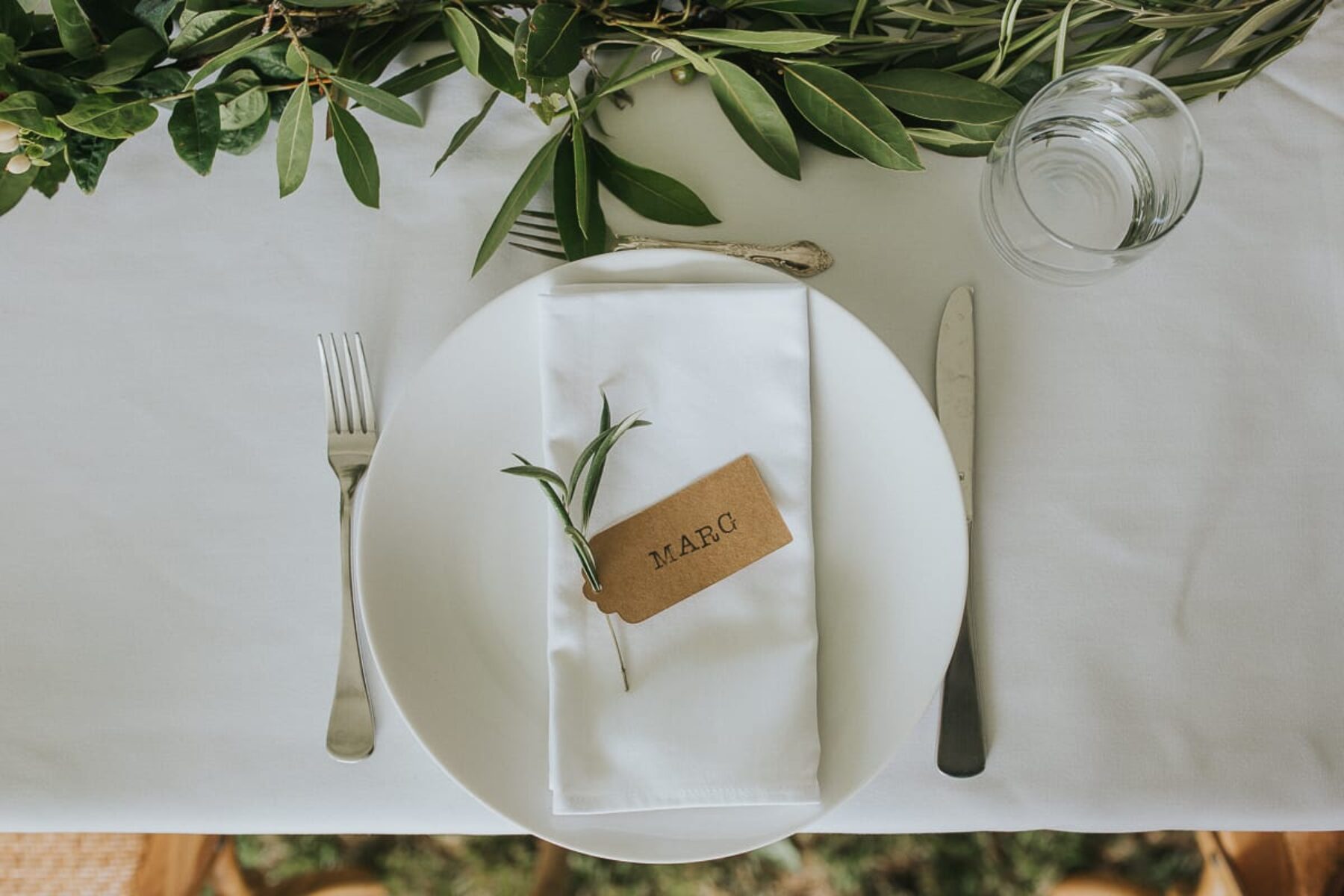 rustic table setting with olive leaf runner